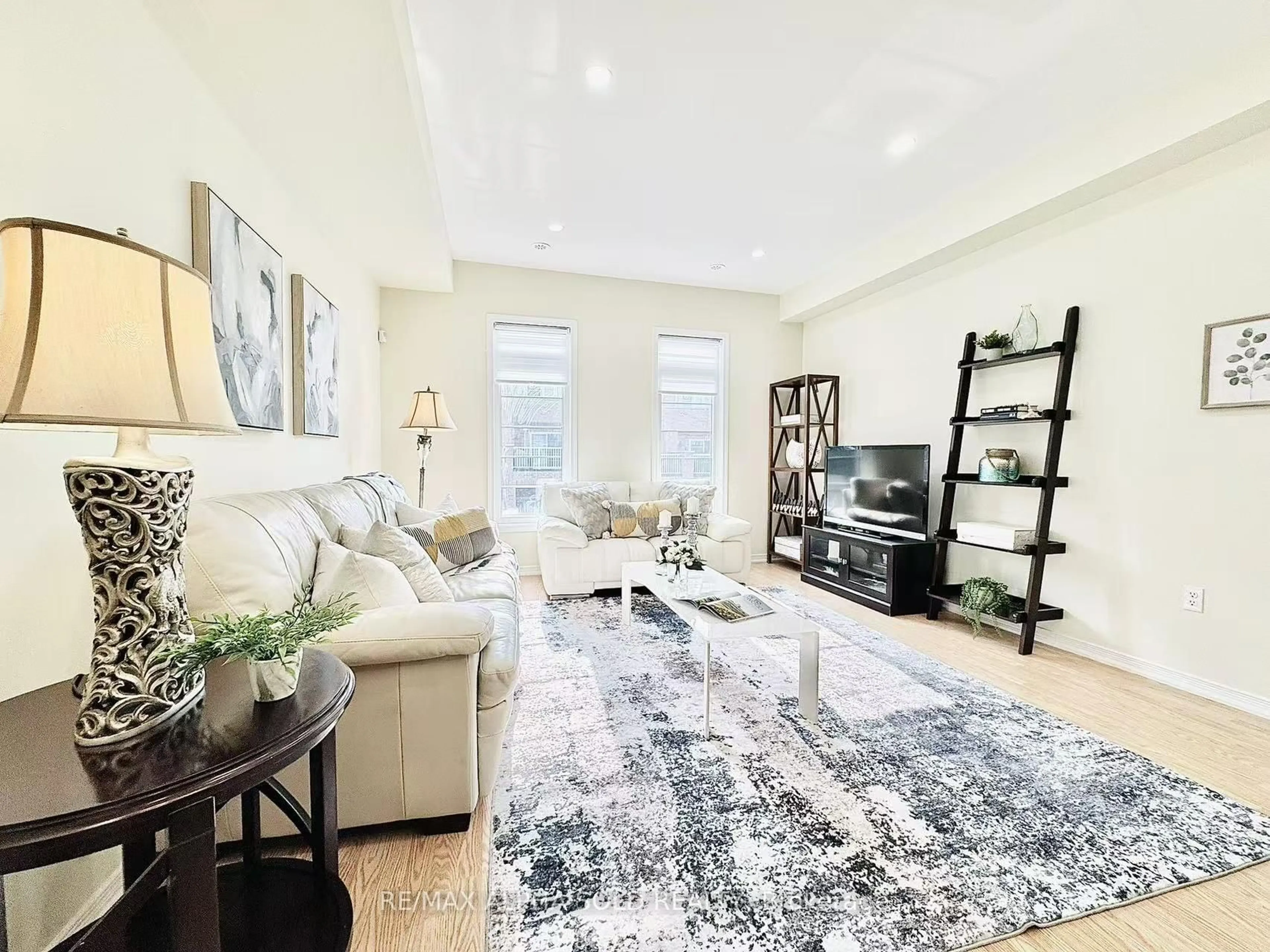 Living room with furniture, wood/laminate floor for 43 Beehive Lane, Markham Ontario L6E 0K6