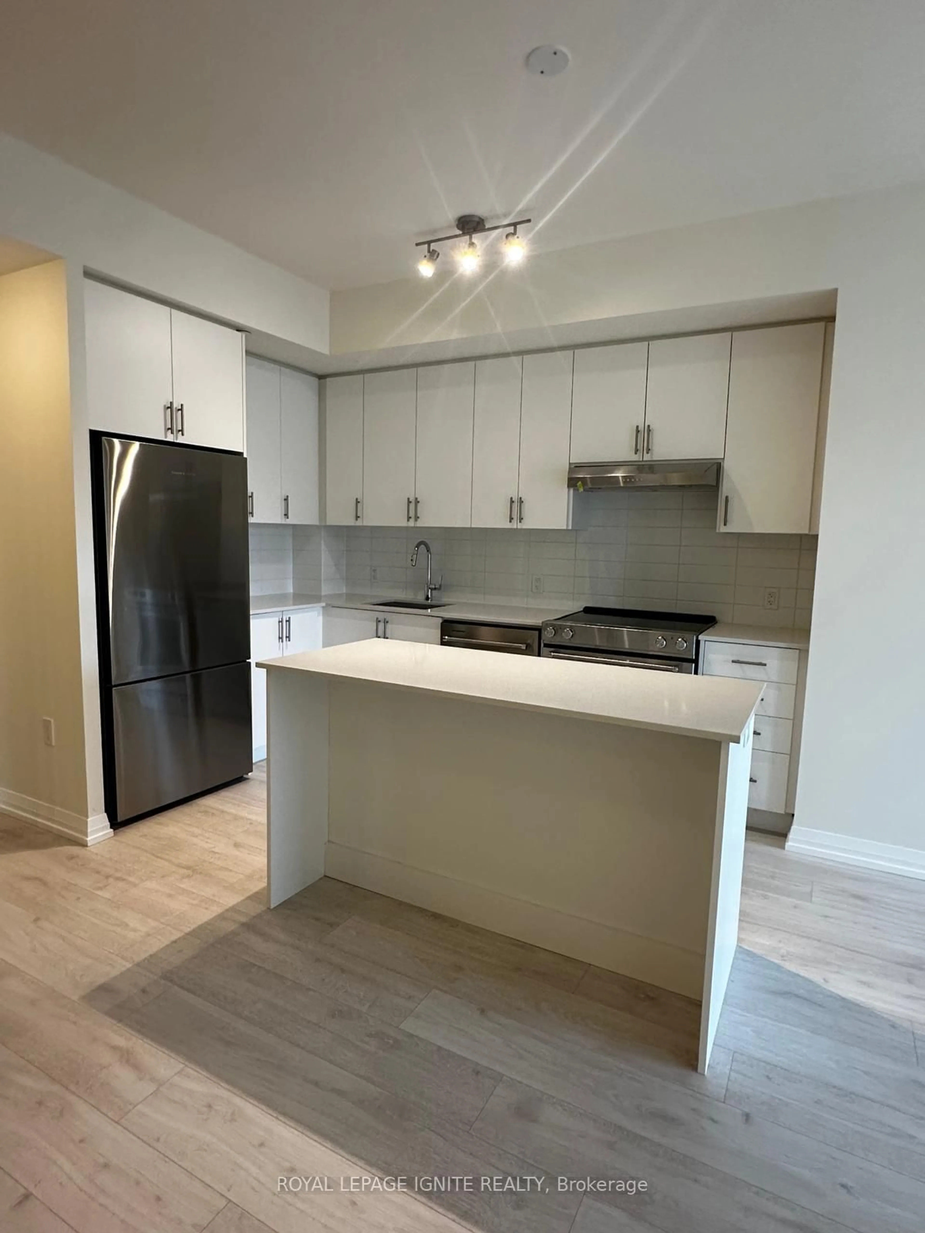 Open concept kitchen, wood/laminate floor for 27 Korda Gate #209, Vaughan Ontario L4K 2M9