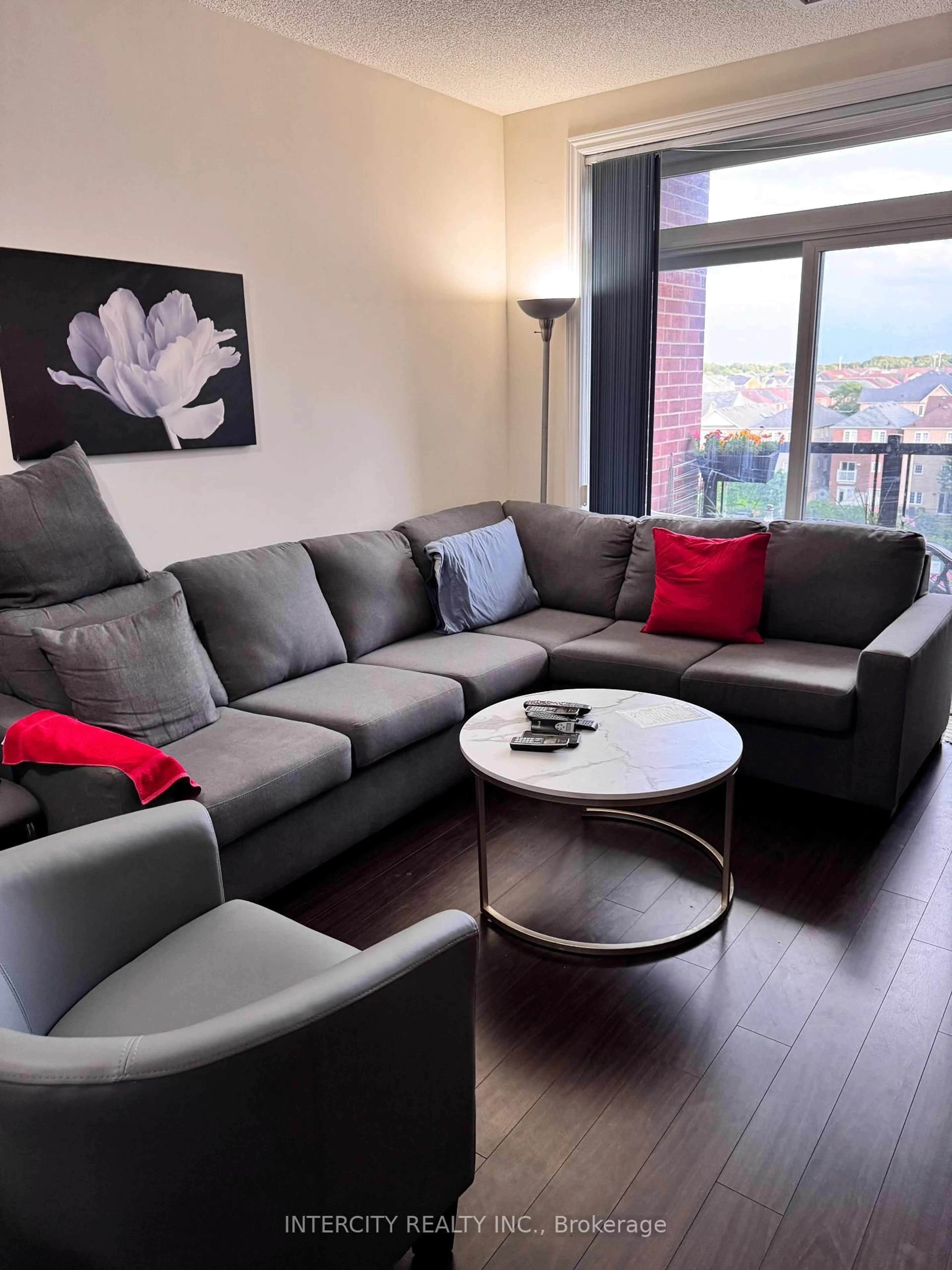 Living room with furniture, wood/laminate floor for 39 New Delhi Dr #412, Markham Ontario L3S 0E1