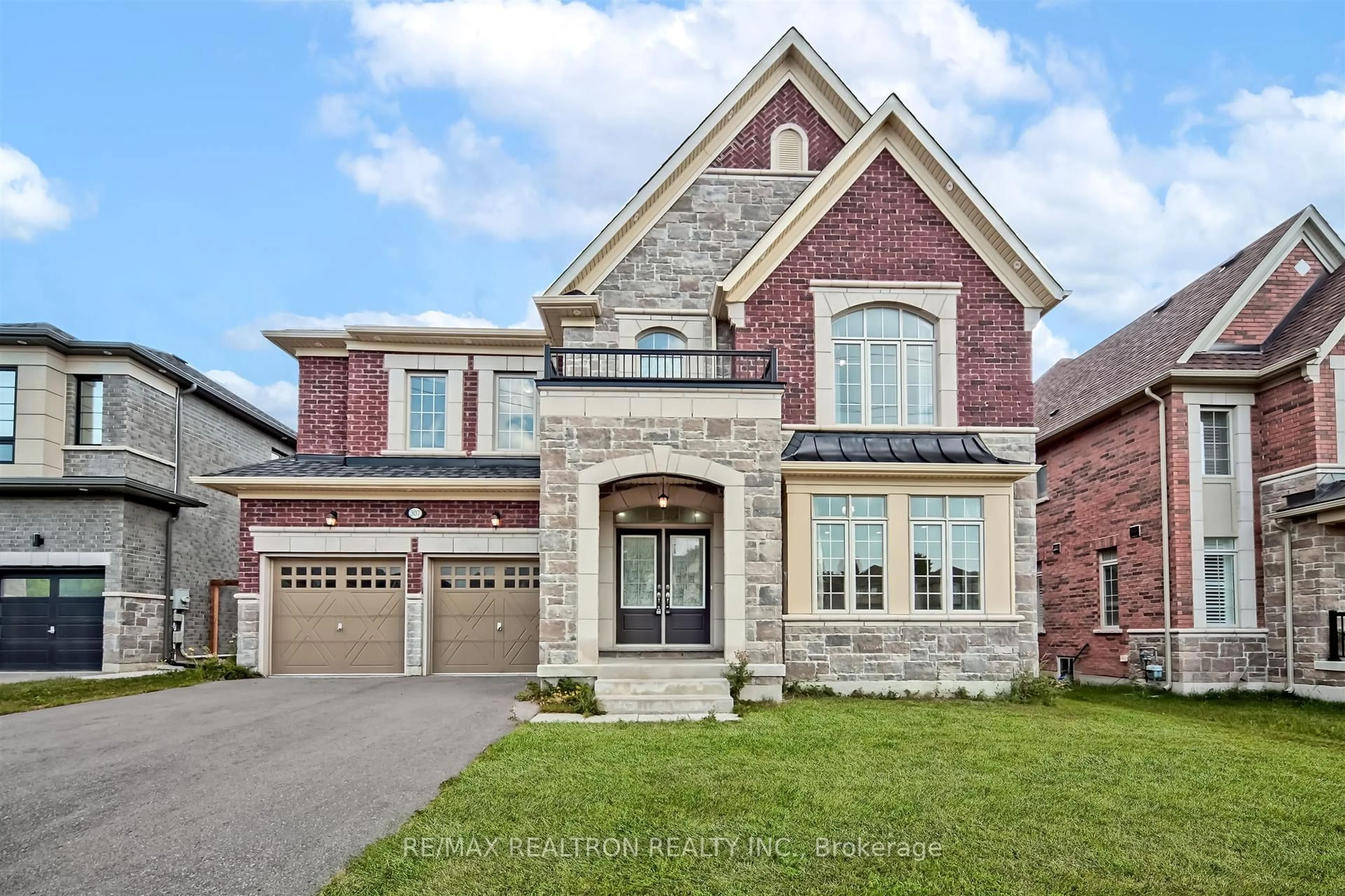 Home with brick exterior material, street for 307 Reginald Harrison Tr, Newmarket Ontario L3X 0M2