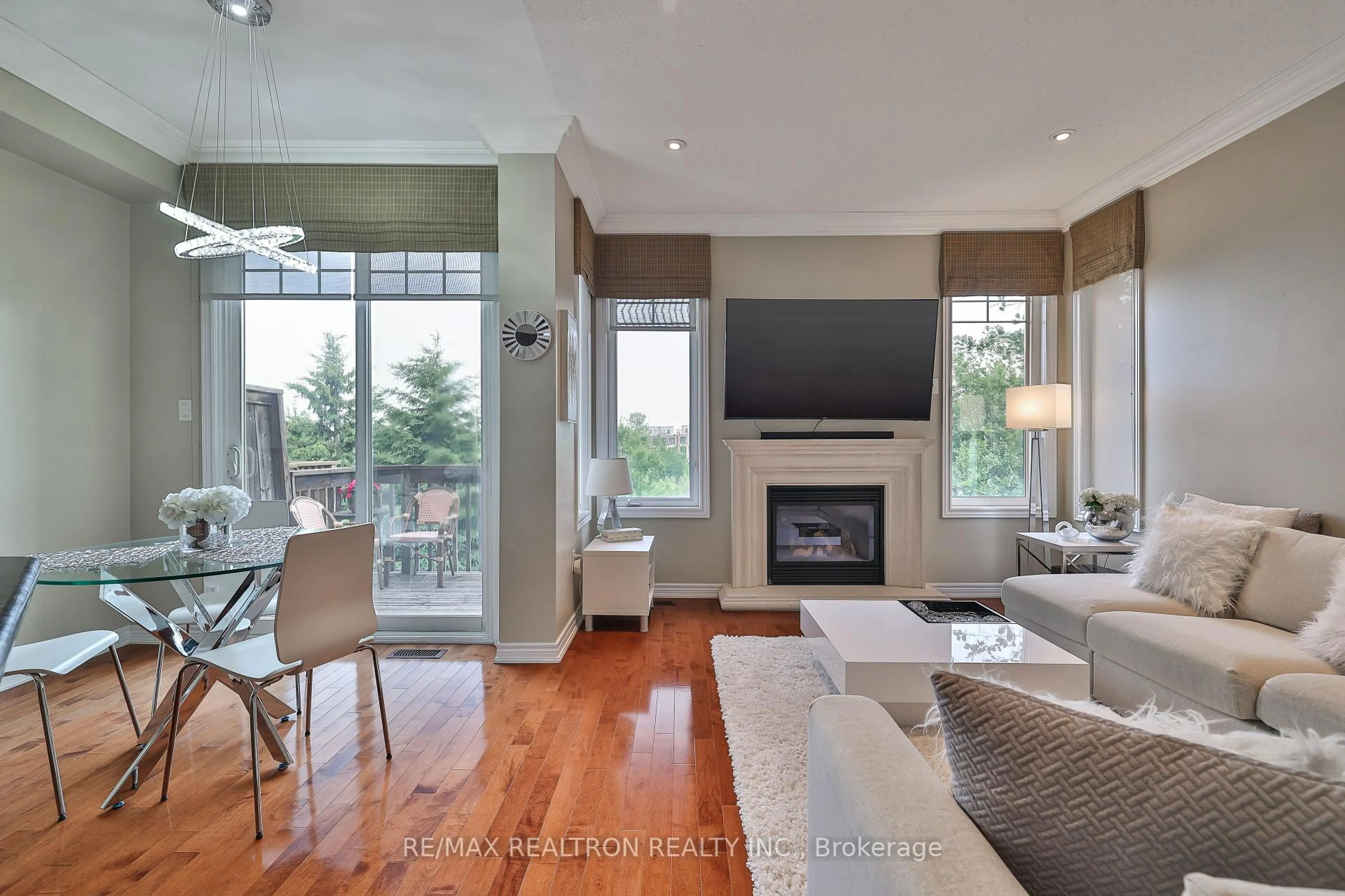 Living room with furniture, wood/laminate floor for 73 Shirrick Dr, Richmond Hill Ontario L4E 0B6