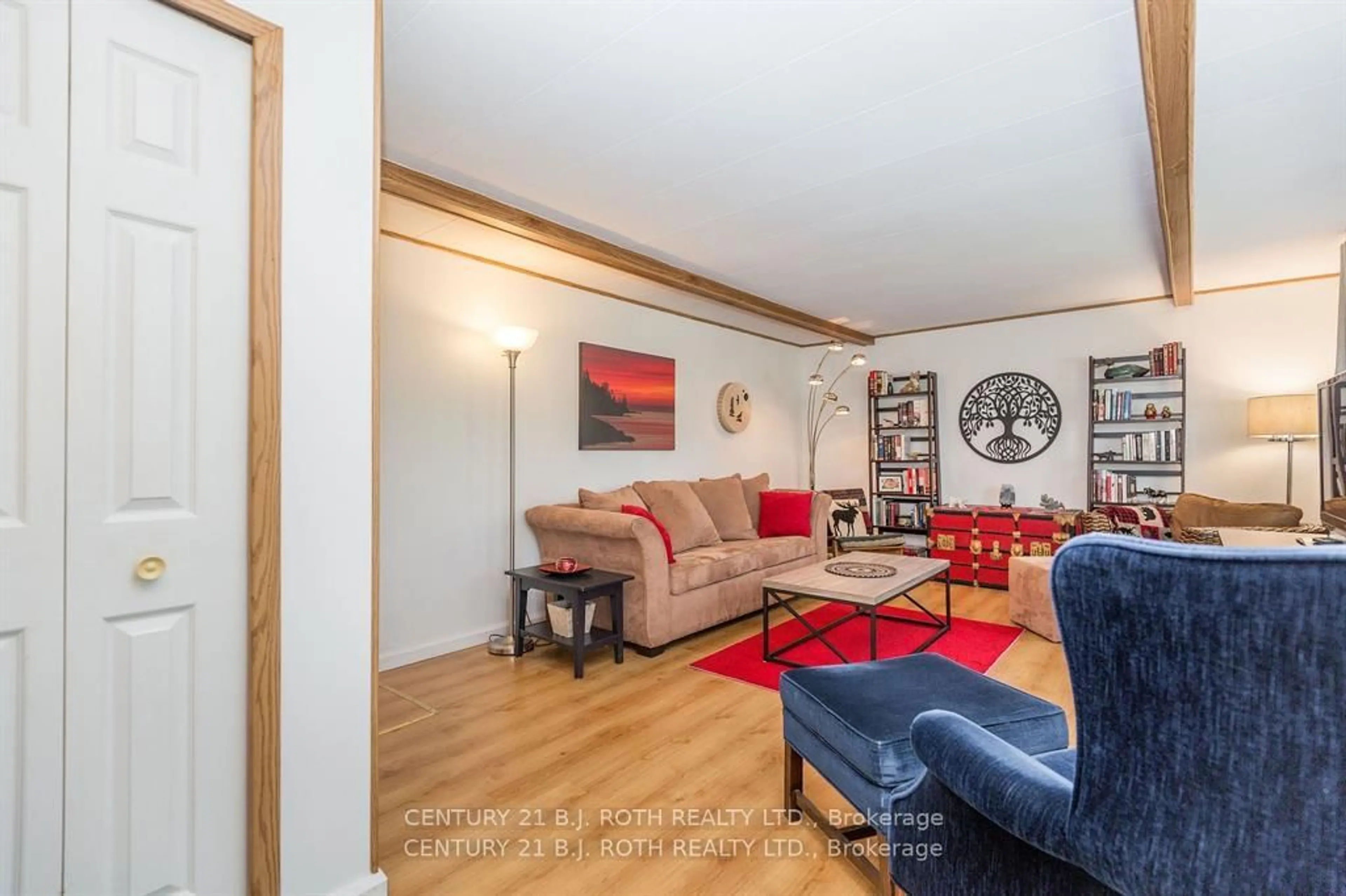 Living room with furniture, wood/laminate floor for 63 Flora Dr, Innisfil Ontario L9S 1R1
