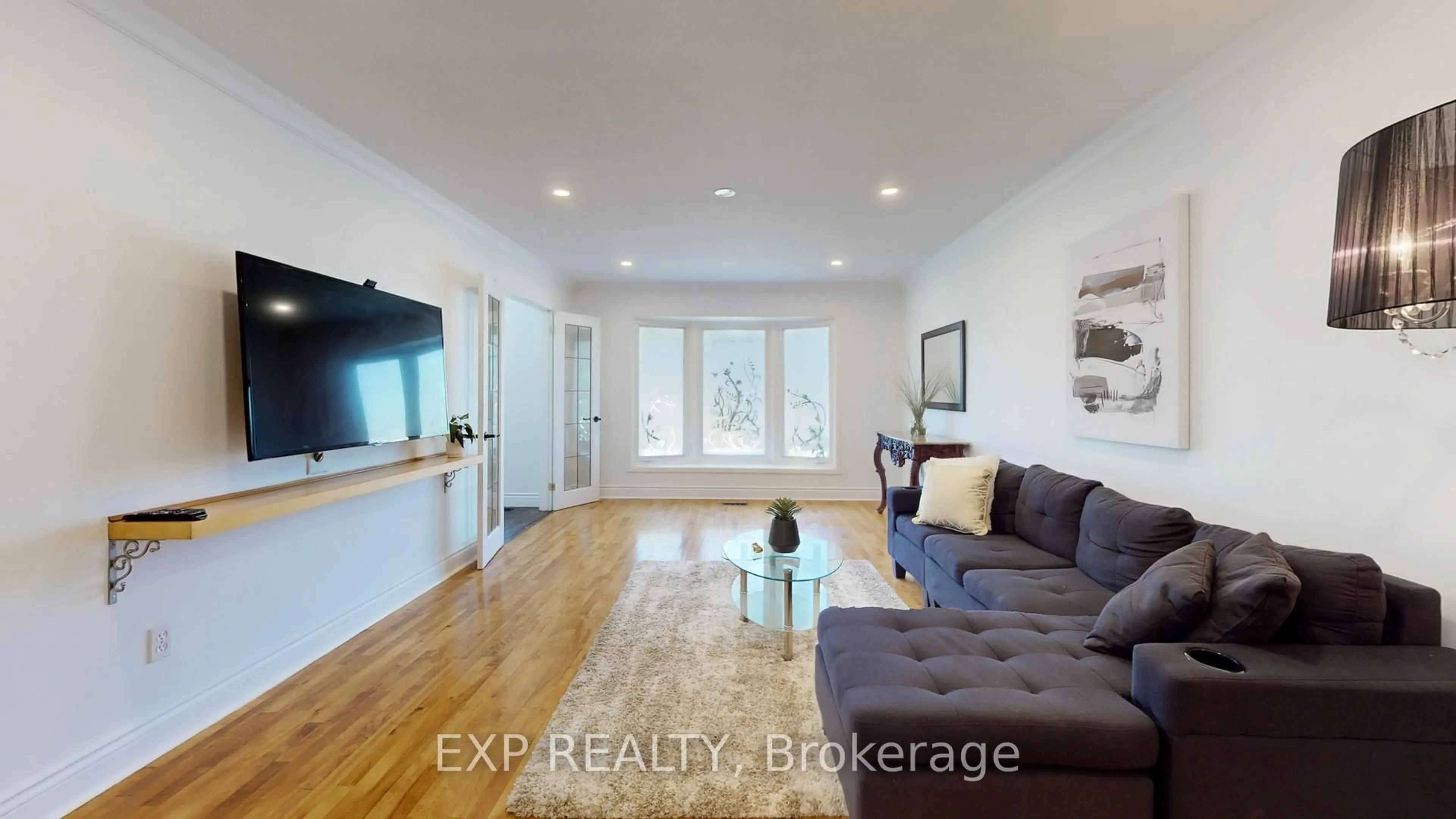 Living room with furniture, wood/laminate floor for 65 Lowe Blvd, Newmarket Ontario L3Y 6H1