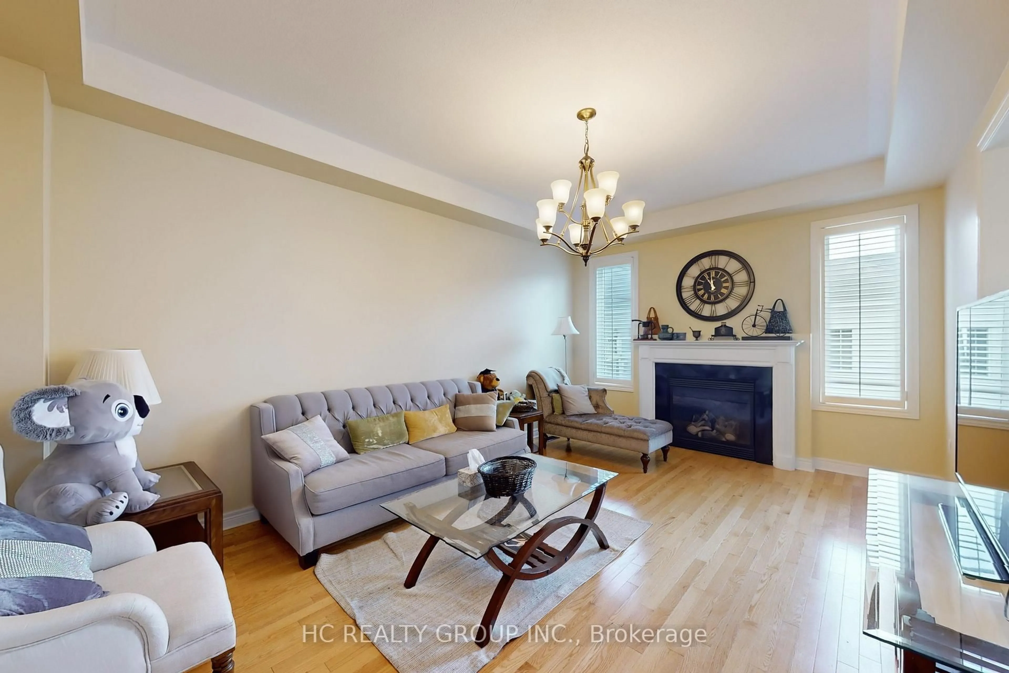 Living room with furniture, wood/laminate floor for 97 Morning Dove Dr, Markham Ontario L6B 1M3