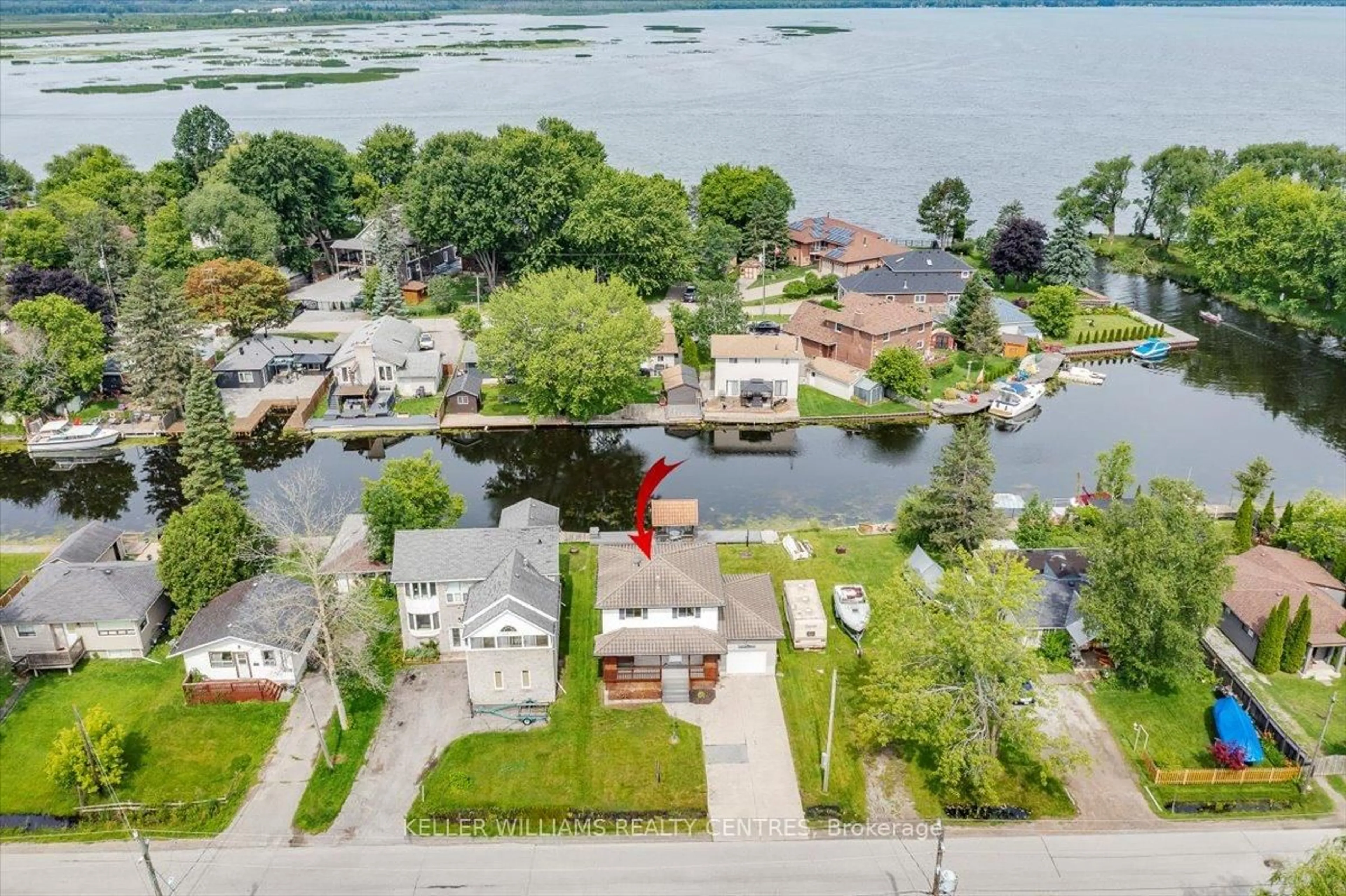 A pic from outside/outdoor area/front of a property/back of a property/a pic from drone, water/lake/river/ocean view for 612 Lake Dr, Georgina Ontario L4P 1T5