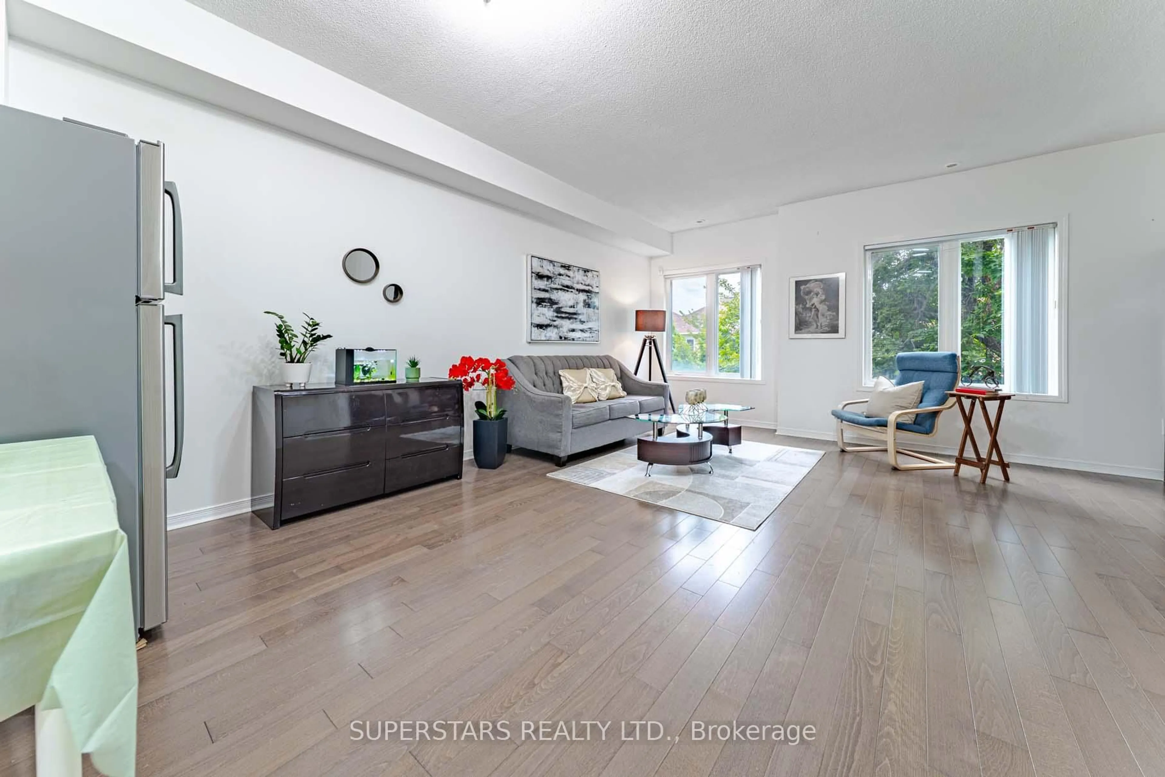 Living room with furniture, wood/laminate floor for 4608 Steeles Ave #TH4, Markham Ontario L3R 6B6
