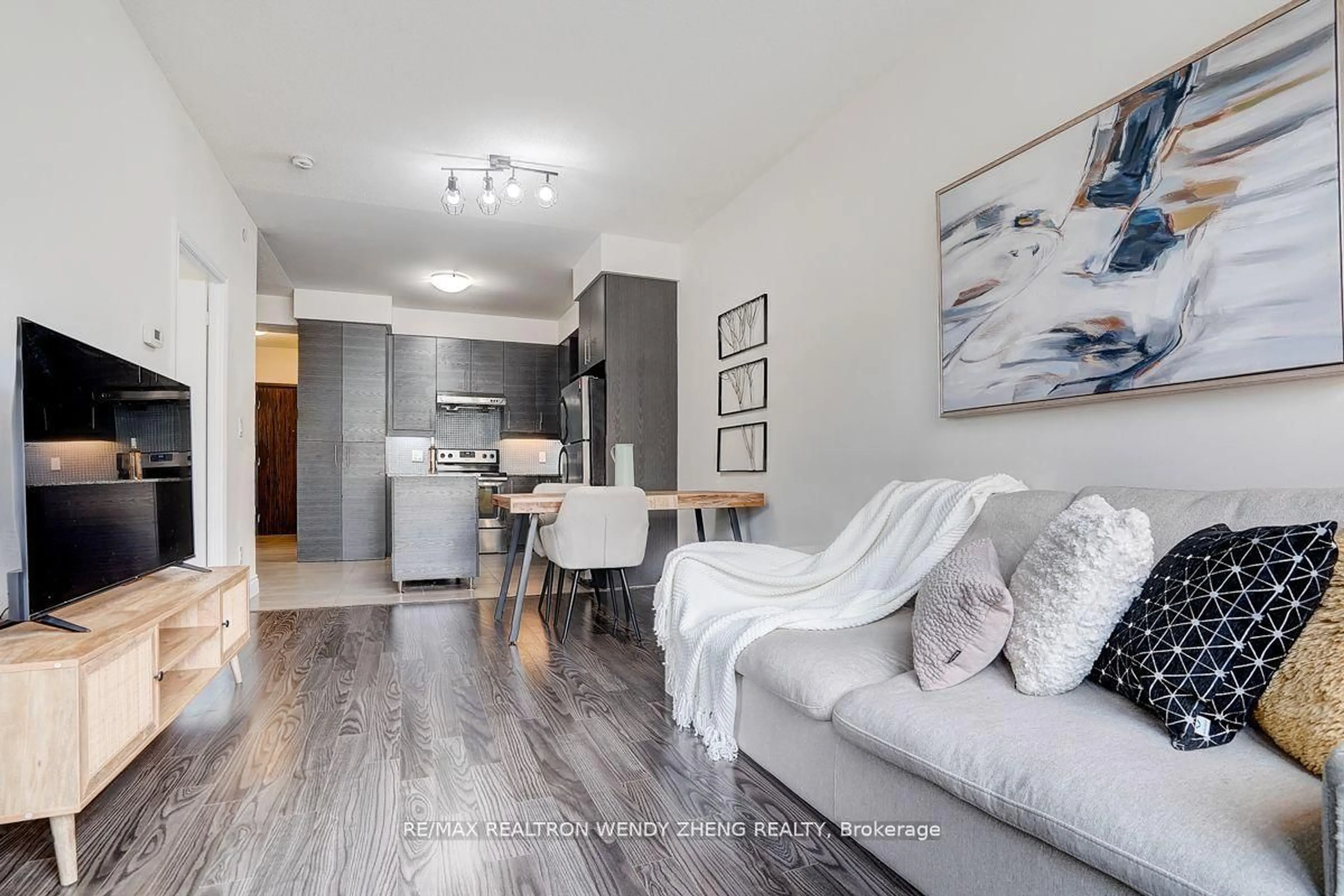 Living room with furniture, wood/laminate floor for 277 South Park Rd #201, Markham Ontario L3T 0B7