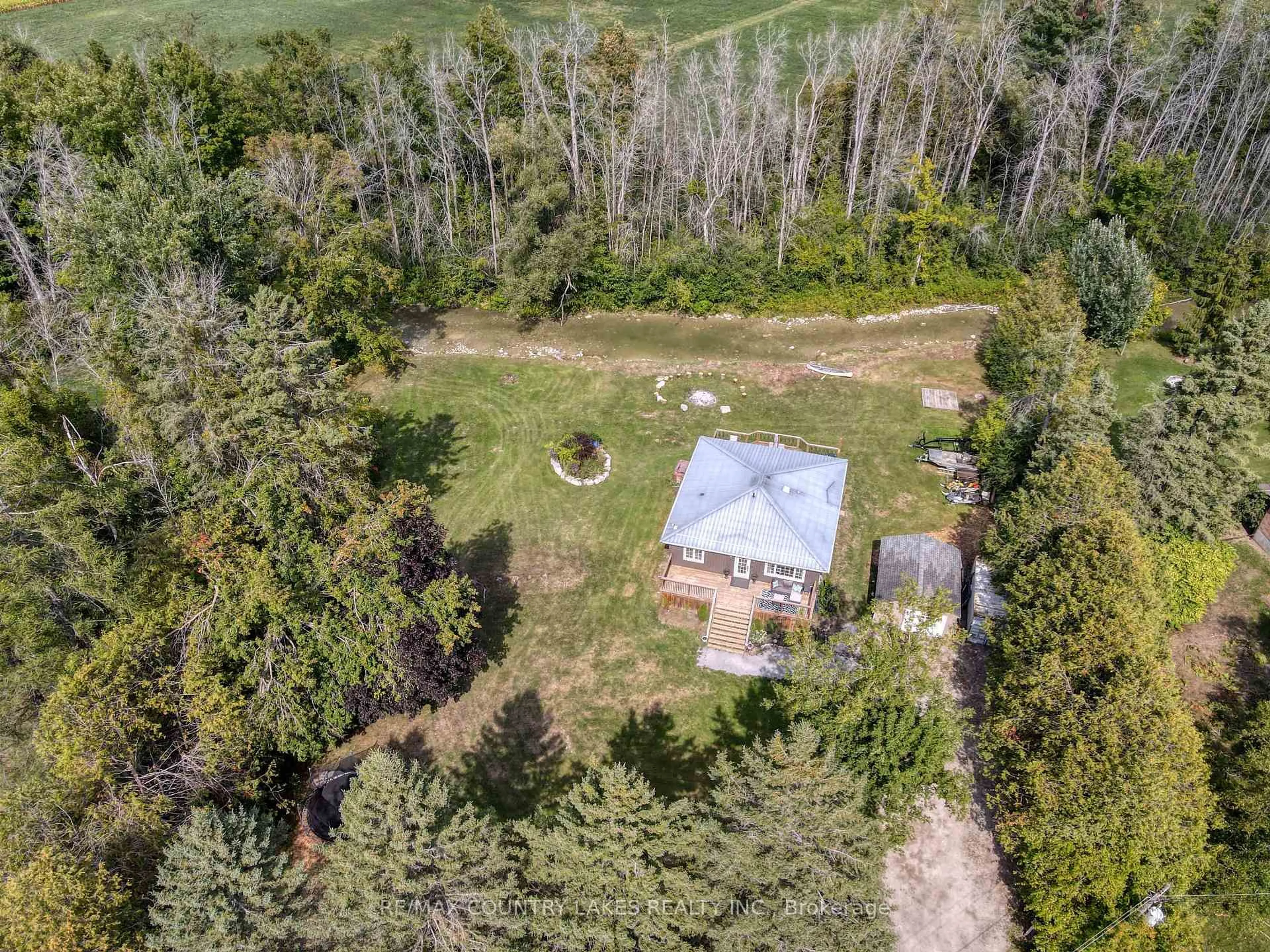 A pic from outside/outdoor area/front of a property/back of a property/a pic from drone, forest/trees view for 15 Patricia Cres, Brock Ontario L0K 1A0