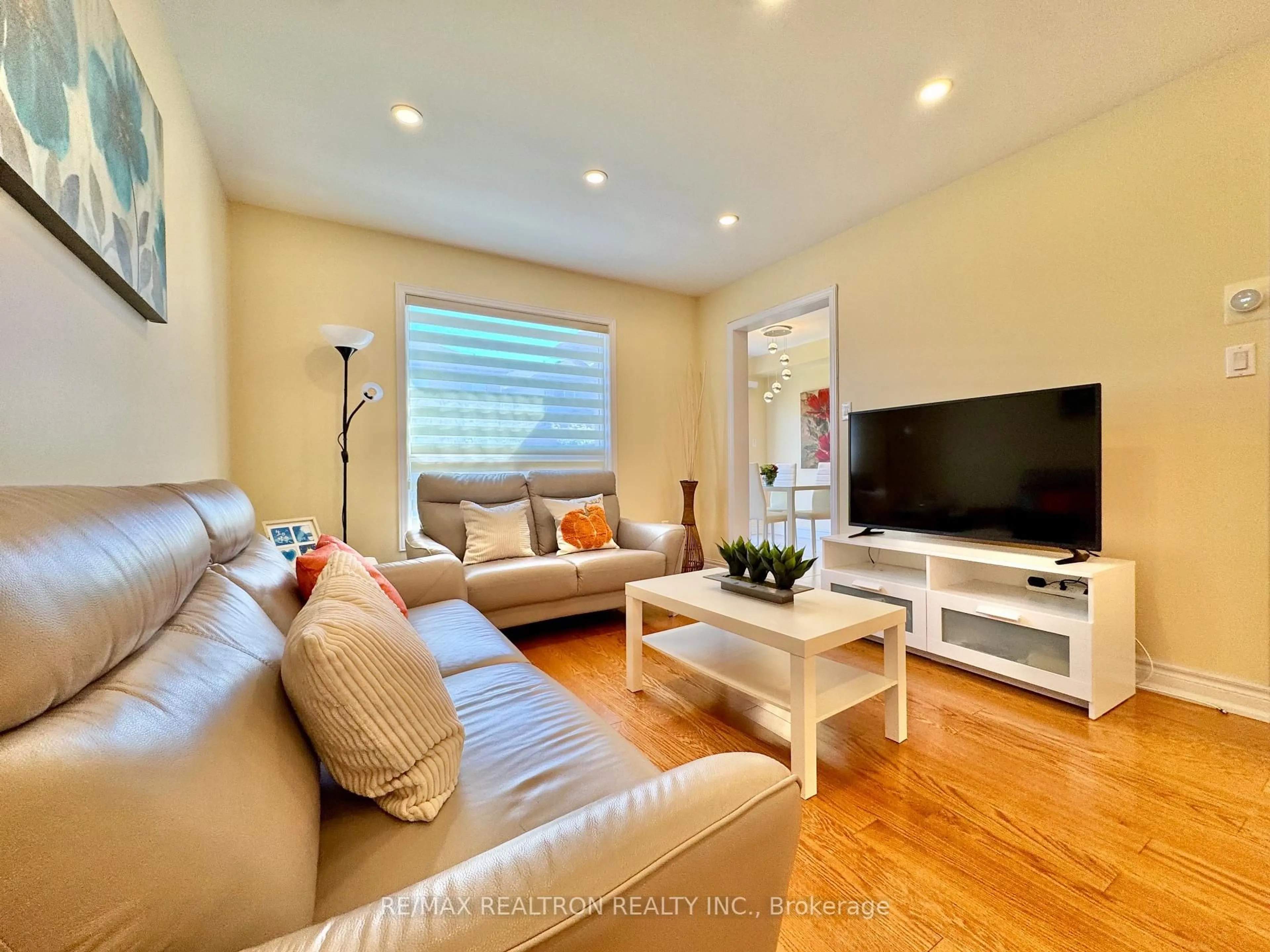 Living room with furniture, wood/laminate floor for 55 Devonwood Dr, Markham Ontario L6C 3E9