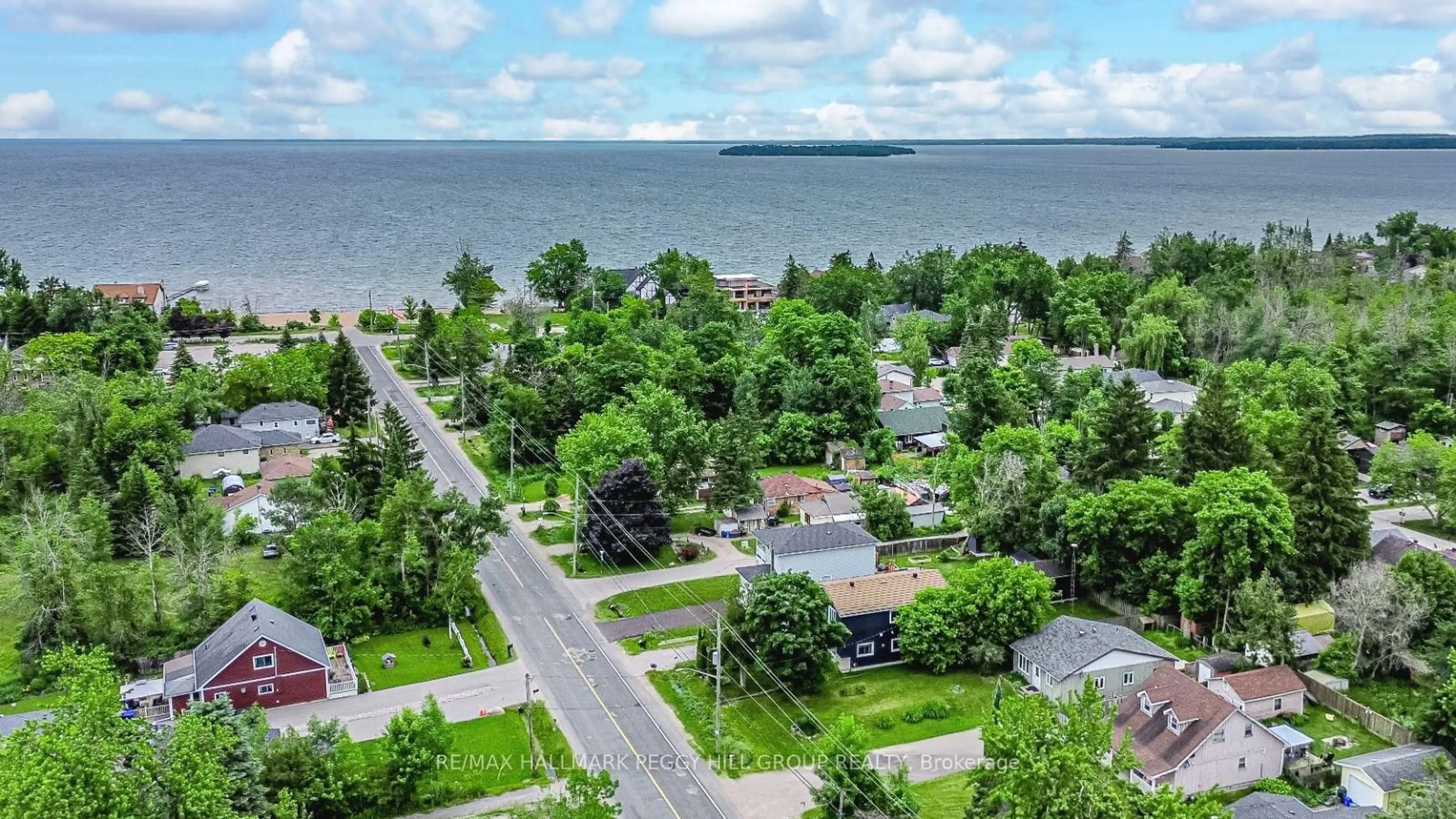 A pic from outside/outdoor area/front of a property/back of a property/a pic from drone, water/lake/river/ocean view for 679 10th Line, Innisfil Ontario L9S 3N2