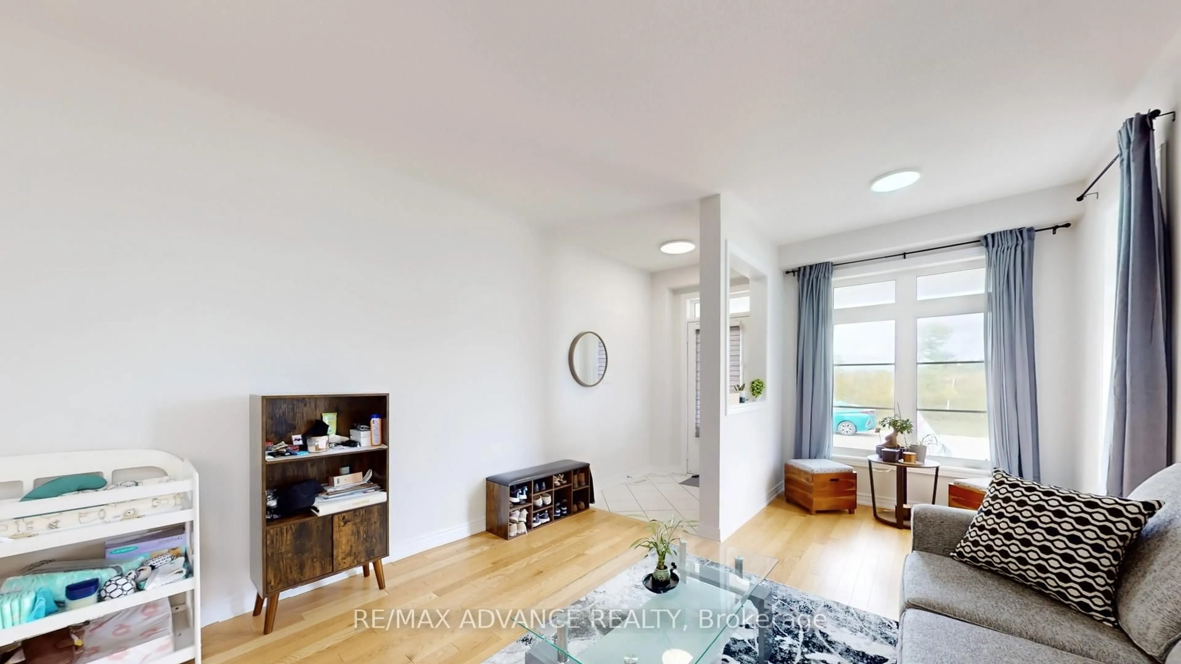 Living room with furniture, wood/laminate floor for 127 Decast Cres, Markham Ontario L6B 1N8