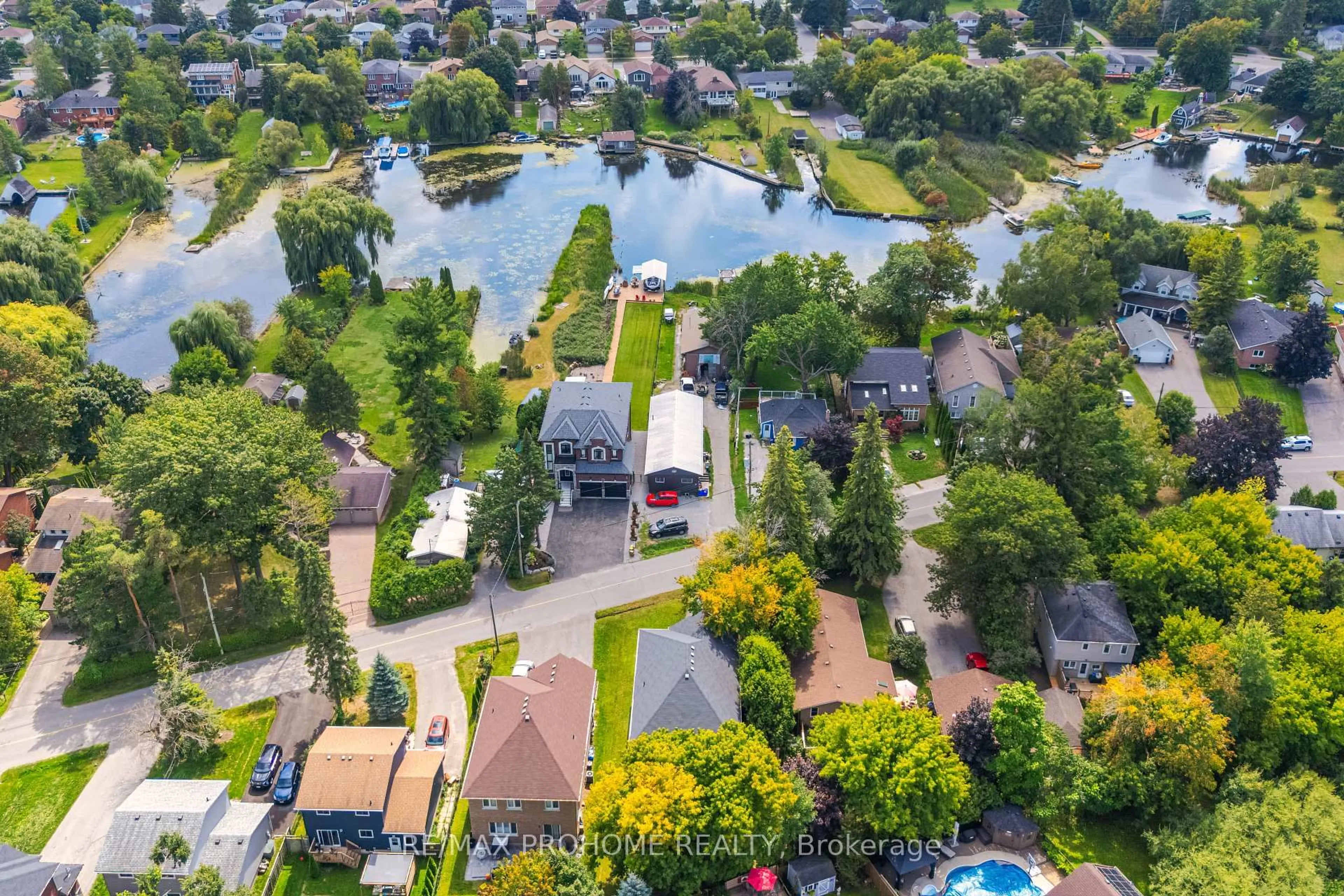 A pic from outside/outdoor area/front of a property/back of a property/a pic from drone, water/lake/river/ocean view for 102 Riveredge Dr, Georgina Ontario L4P 2P1