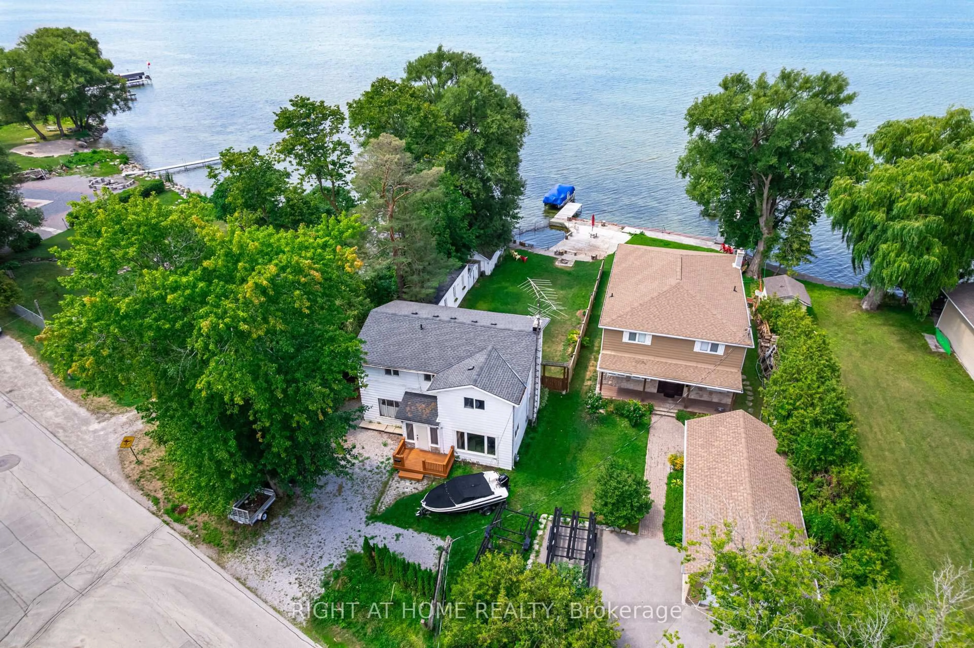 A pic from outside/outdoor area/front of a property/back of a property/a pic from drone, water/lake/river/ocean view for 428 Lake Dr, Georgina Ontario L4P 1P5