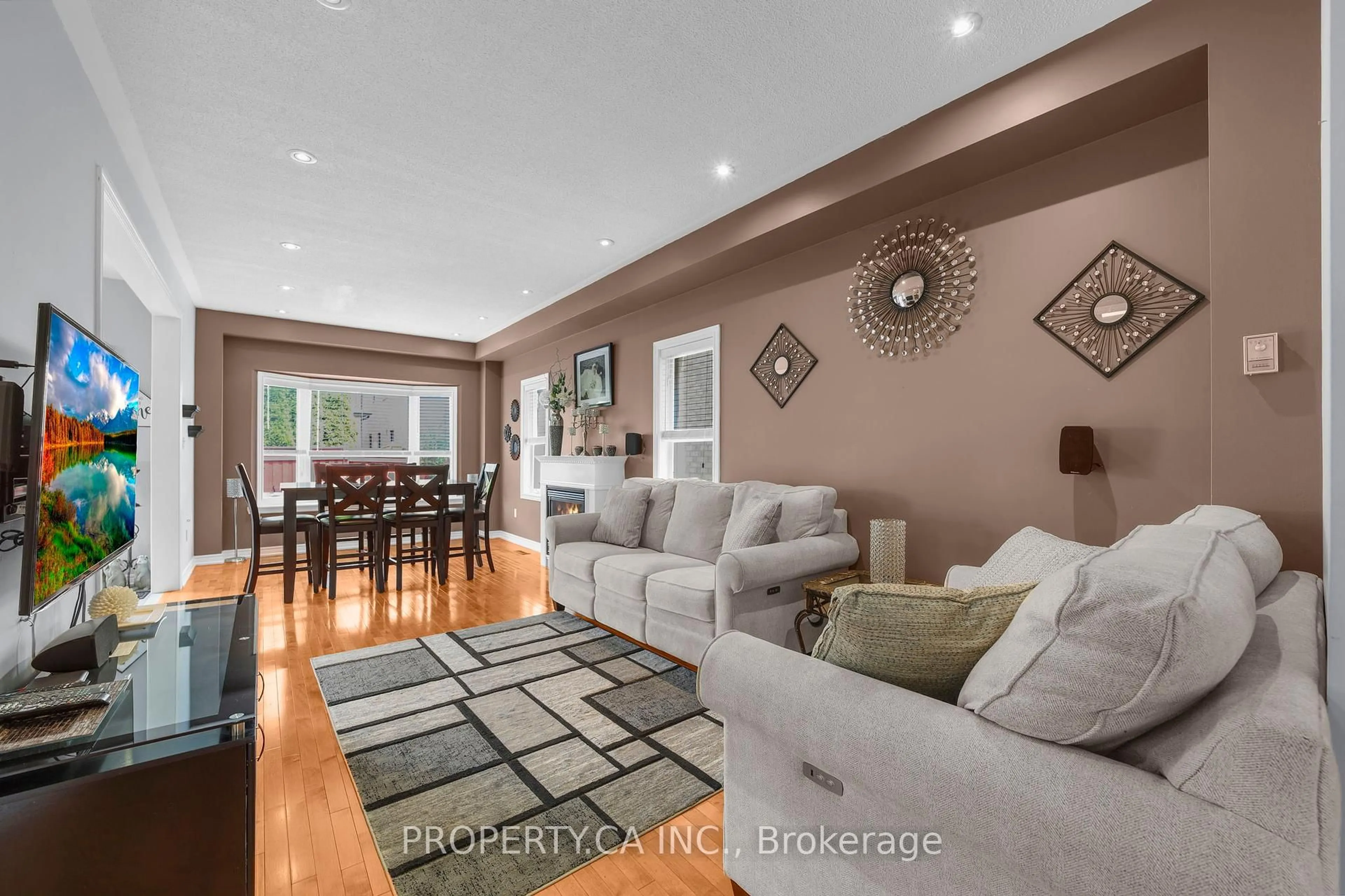 Living room with furniture, wood/laminate floor for 25 Boticelli Way, Vaughan Ontario L4H 0C6