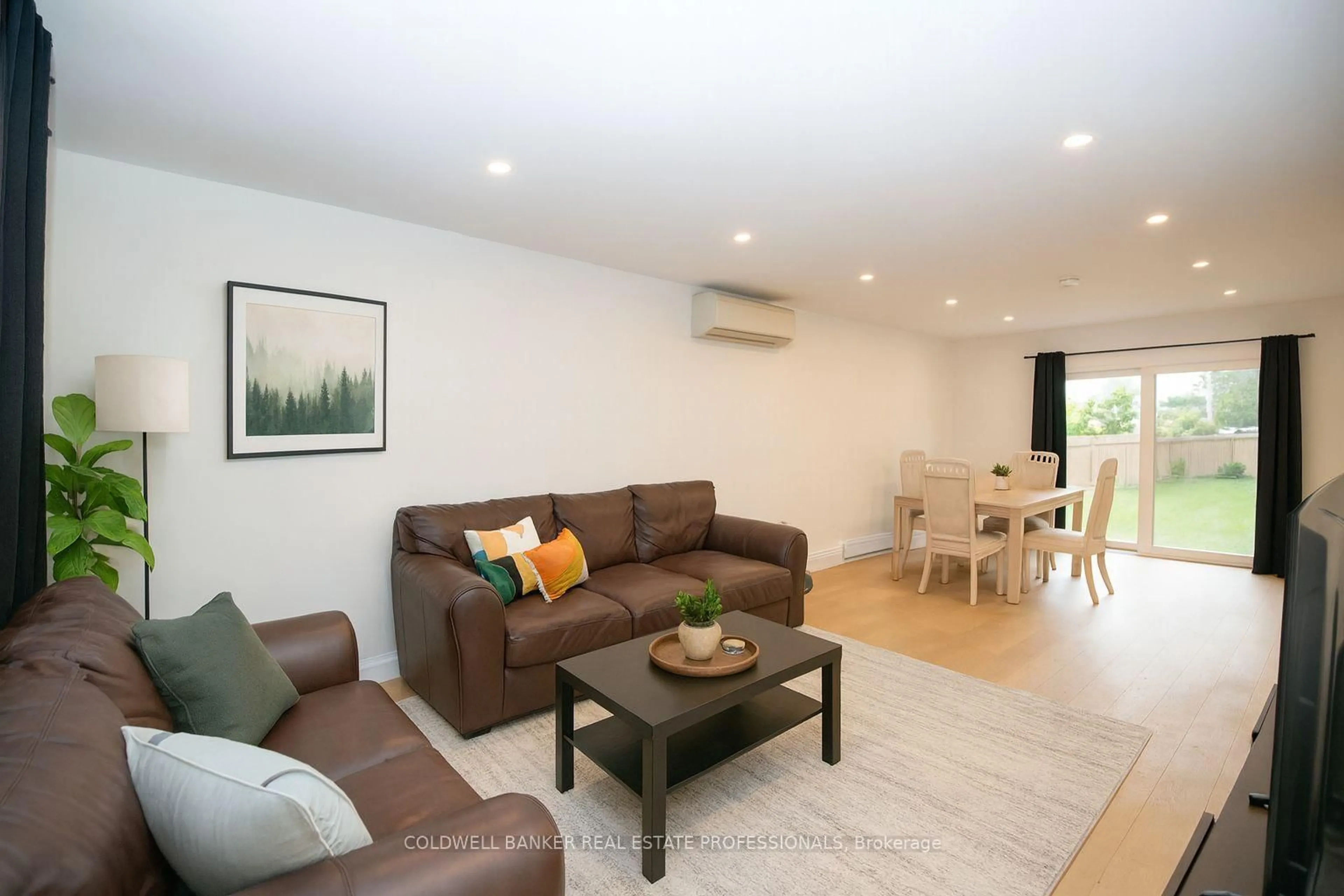 Living room with furniture, wood/laminate floor for 235 Simcoe Ave, Georgina Ontario L4P 2H9