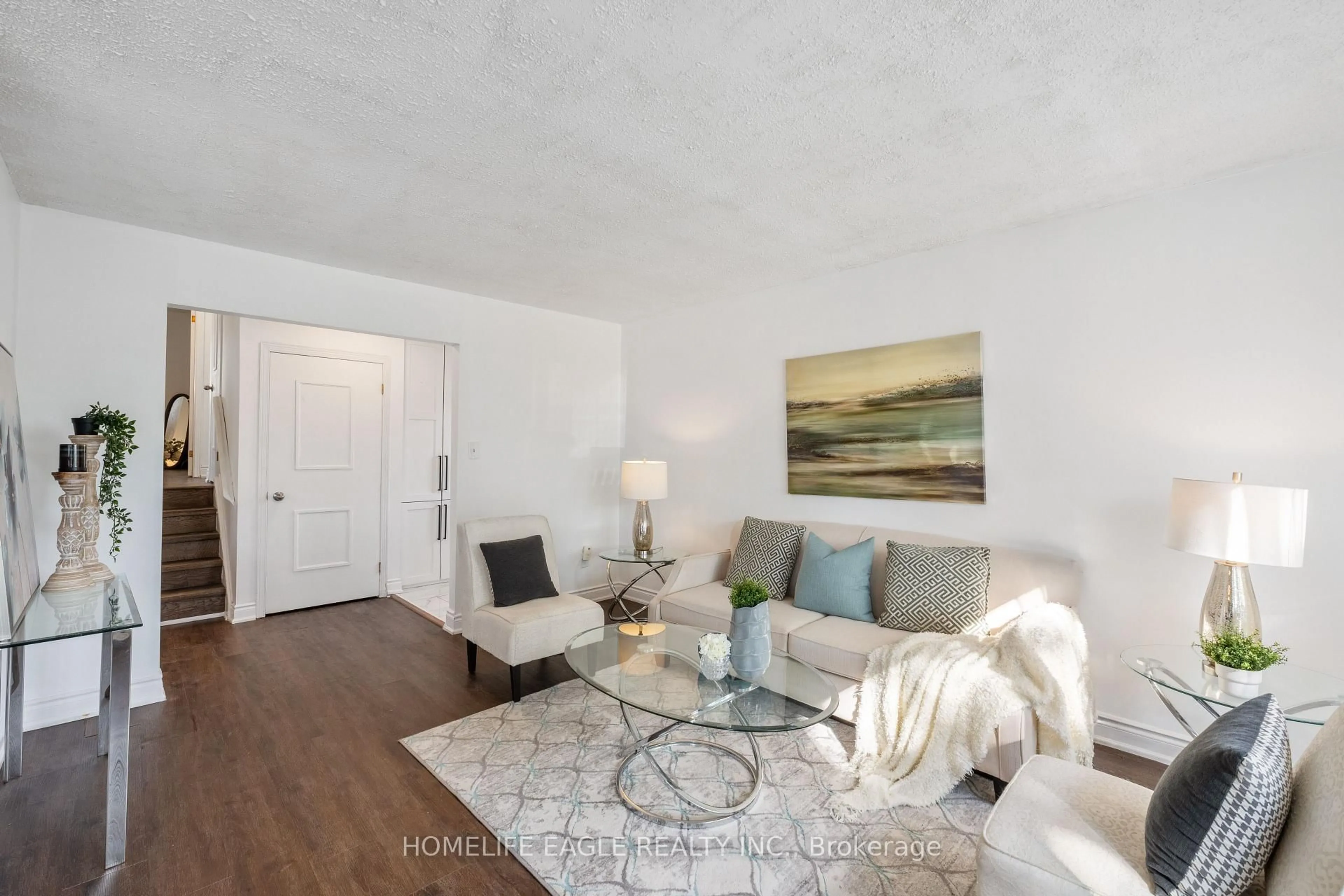 Living room with furniture, wood/laminate floor for 23 Maurino Crt, Bradford West Gwillimbury Ontario L3Z 1S6