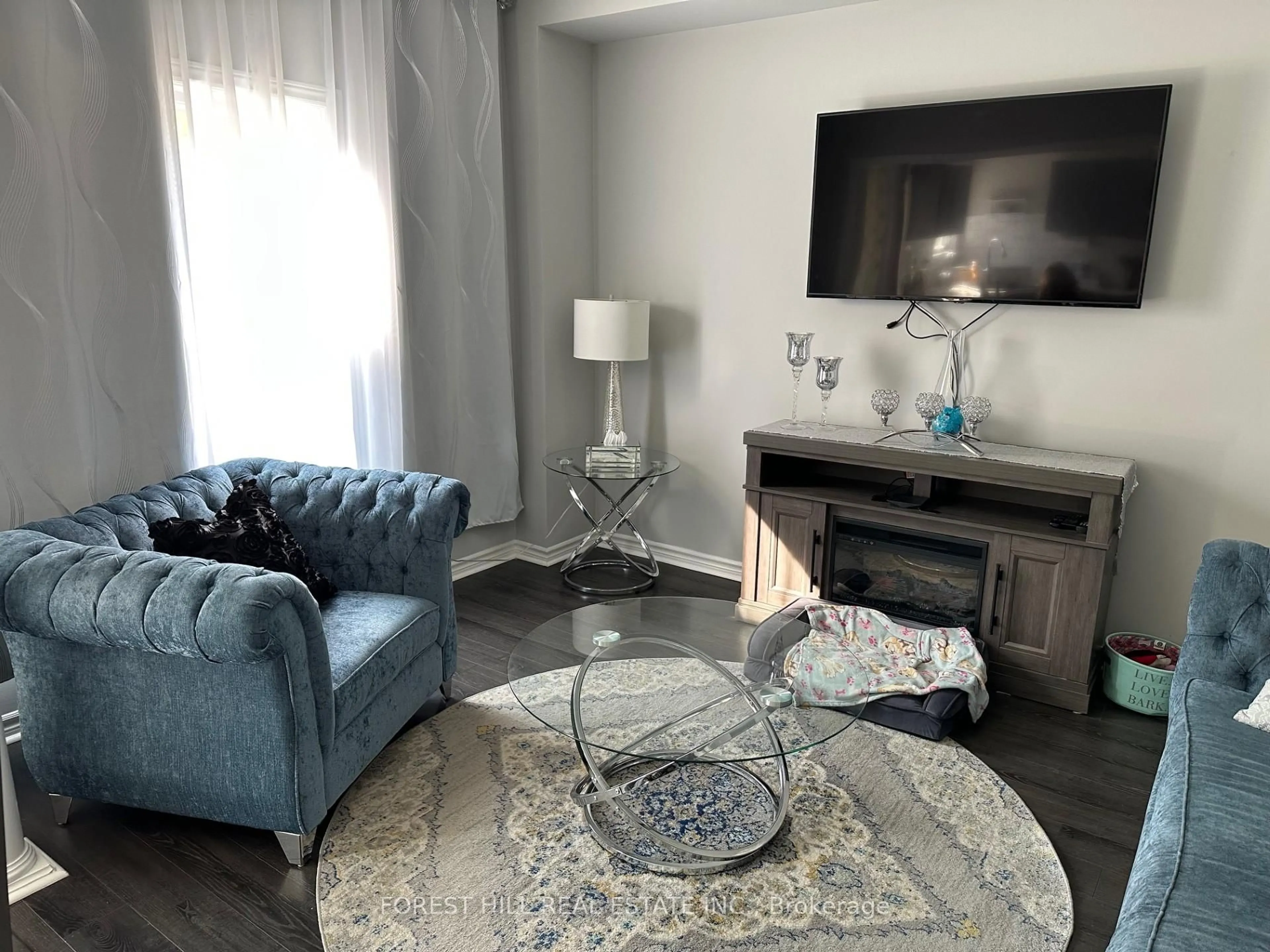 Living room with furniture, wood/laminate floor for 43 Park Place Dr, Markham Ontario L6E 1Z9