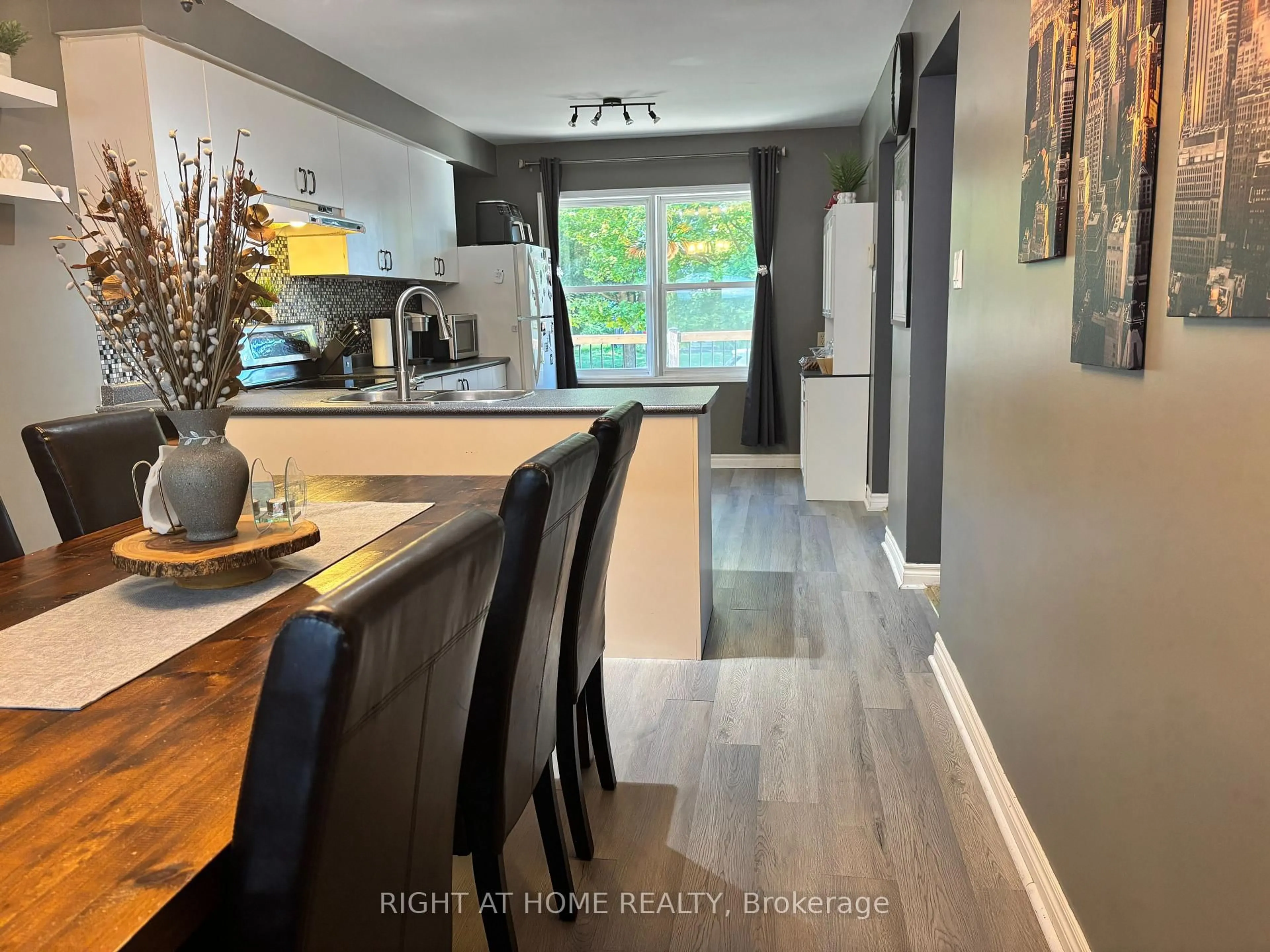 Open concept kitchen, wood/laminate floor for 48 Michael St St, Essa Ontario L3W 0M3