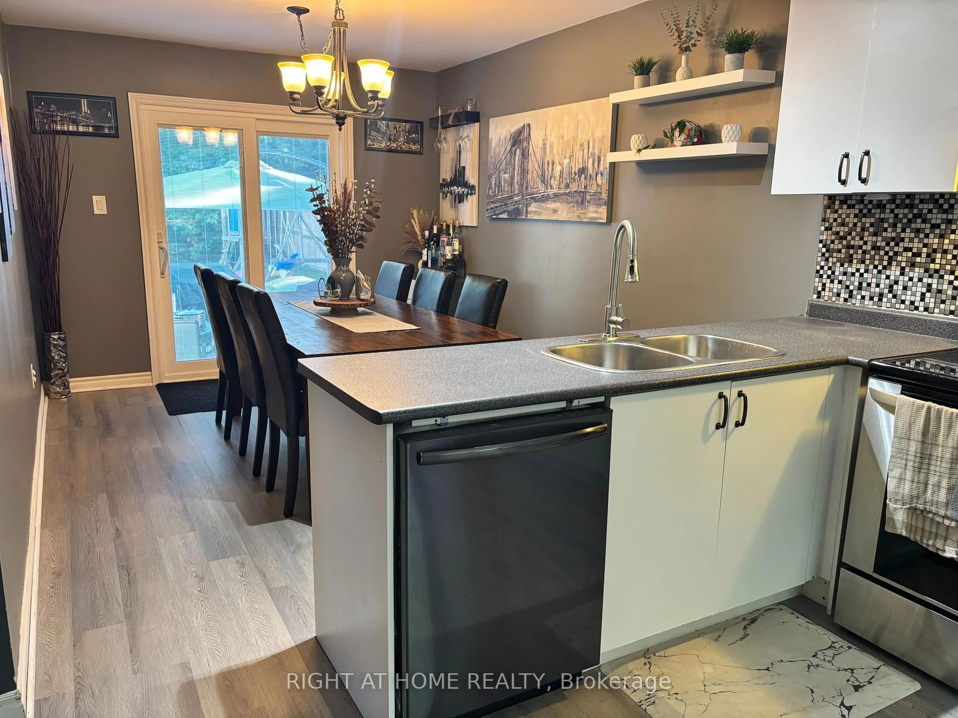 Open concept kitchen, wood/laminate floor for 48 Michael St St, Essa Ontario L3W 0M3