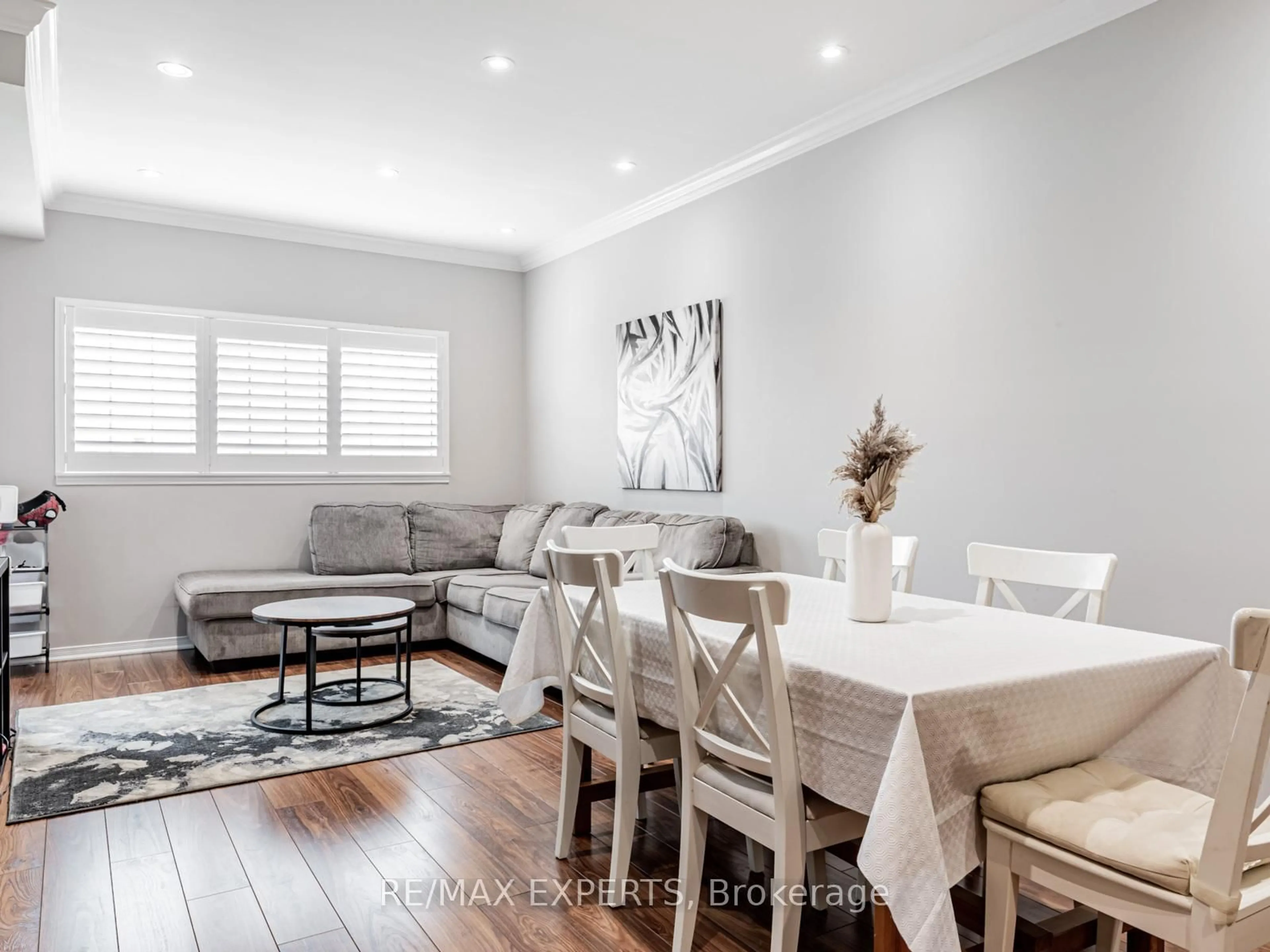 Living room with furniture, wood/laminate floor for 9451 Jane St #310, Vaughan Ontario L6A 4J1