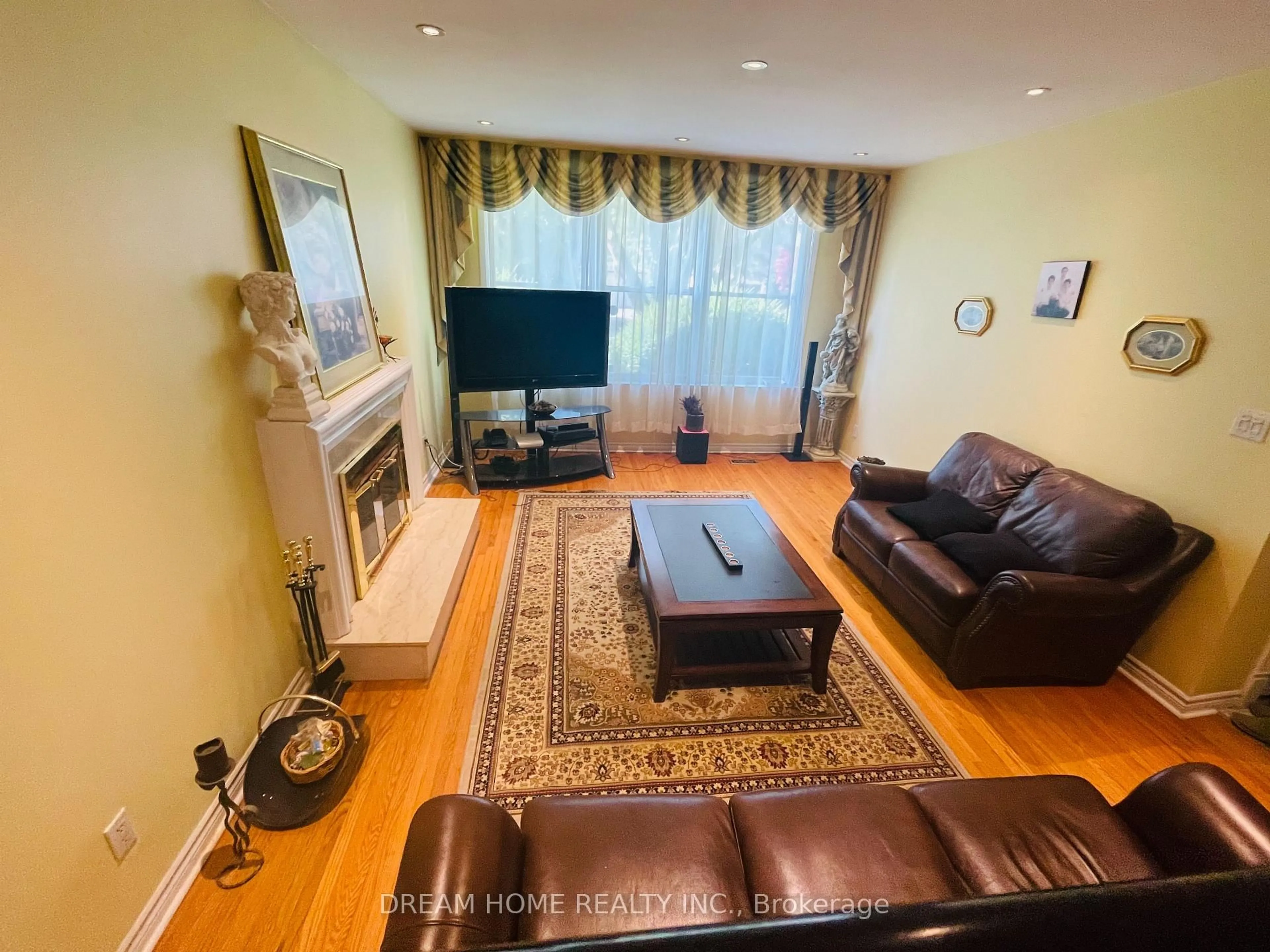 Living room with furniture, wood/laminate floor for 93 Babcombe Dr, Markham Ontario L3T 1M9