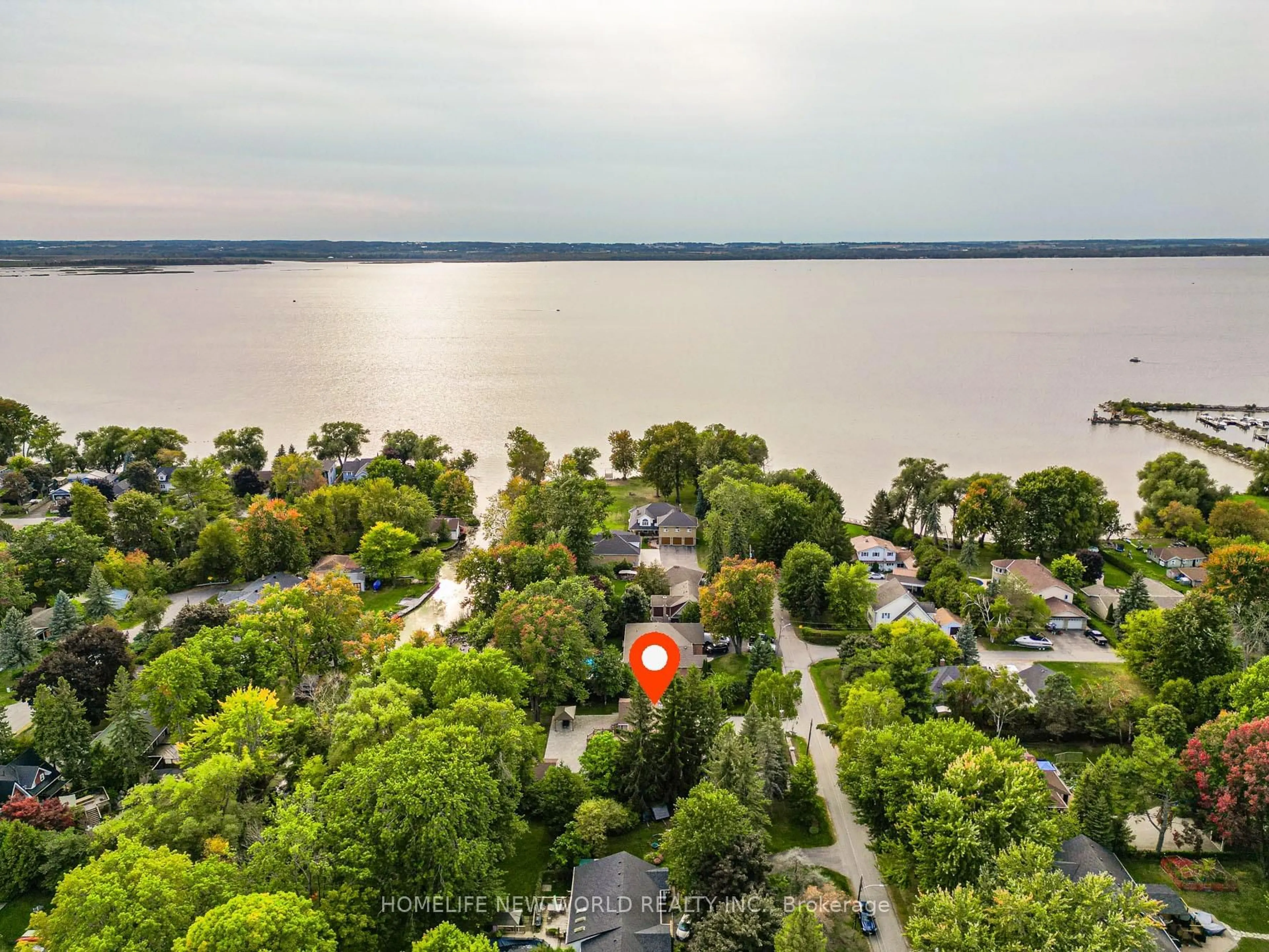 A pic from outside/outdoor area/front of a property/back of a property/a pic from drone, water/lake/river/ocean view for 215 Willow Dr, Georgina Ontario L4P 2R9