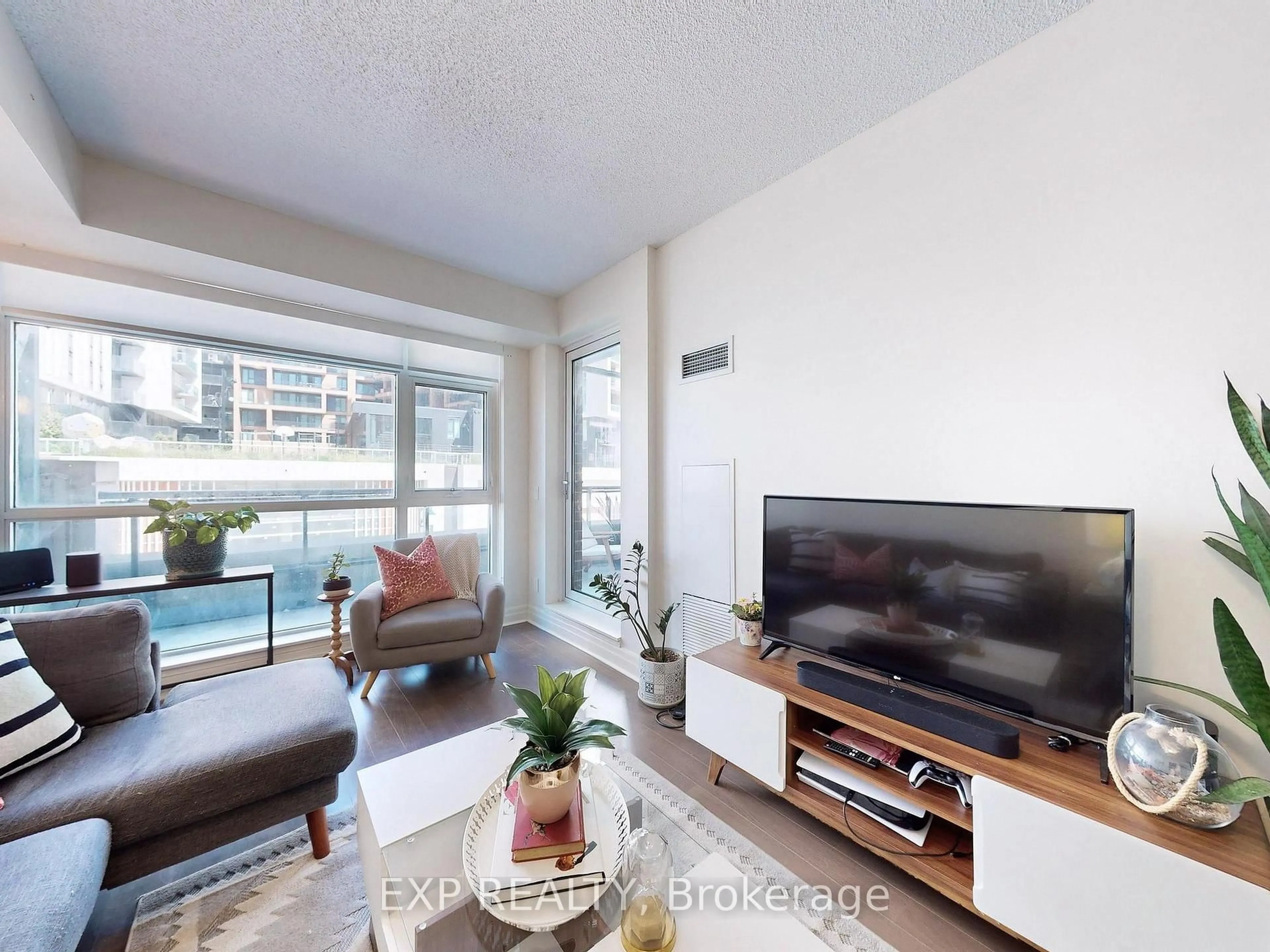 Living room with furniture, wood/laminate floor for 8130 Birchmount Rd #312, Markham Ontario L6G 0E4