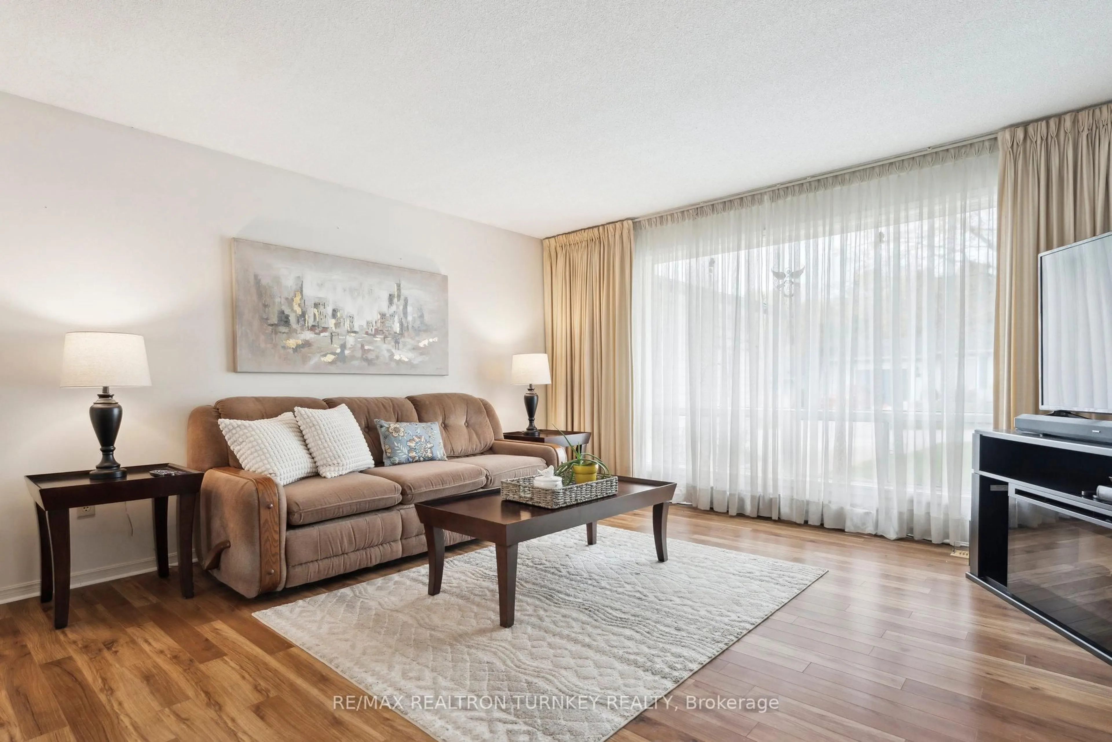 Living room with furniture, wood/laminate floor for 36 Tecumseth Pines Dr, New Tecumseth Ontario L0G 1W0