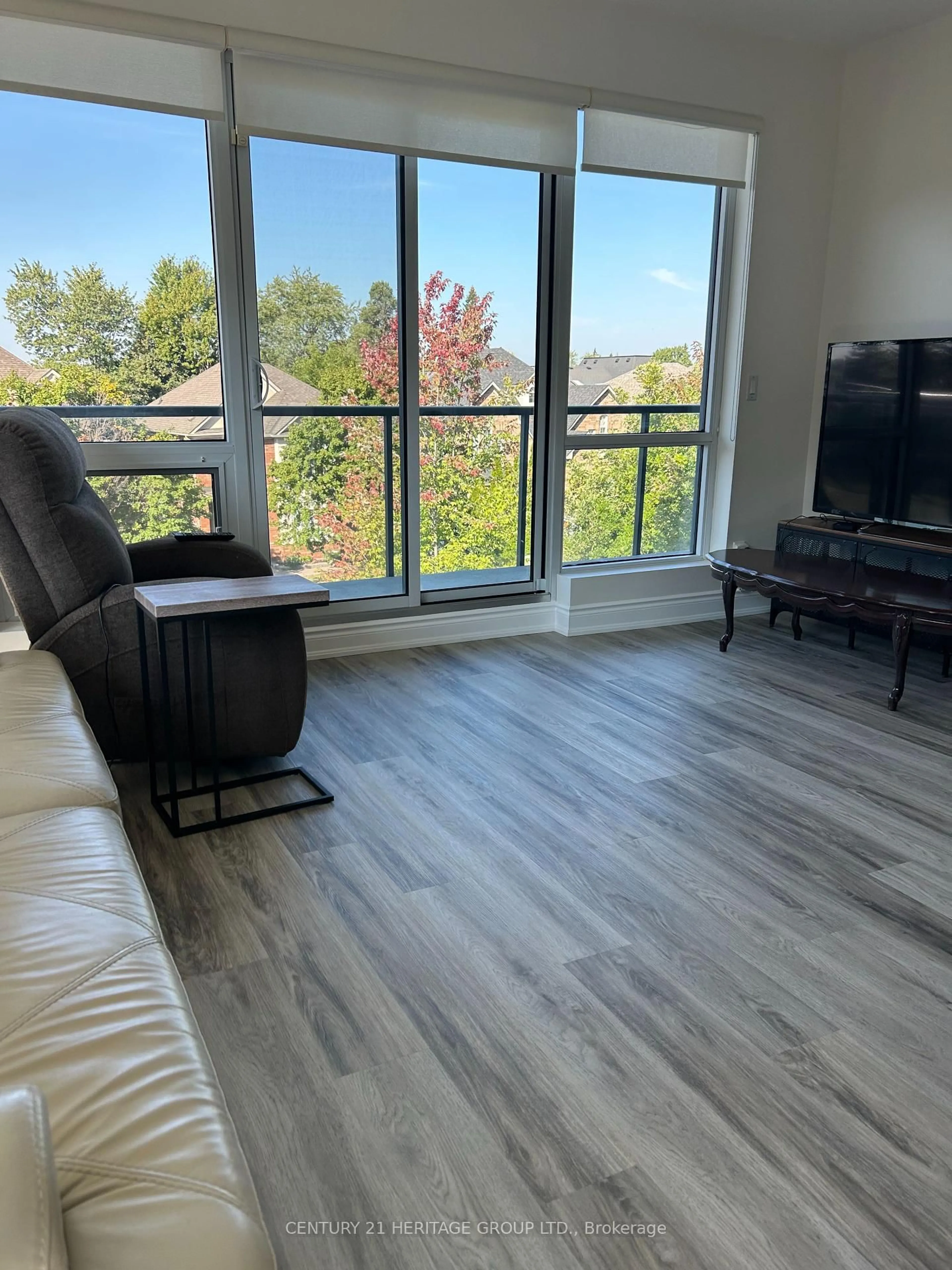 Living room with furniture, wood/laminate floor for 9088 Yonge St #203, Richmond Hill Ontario L4C 0Y6