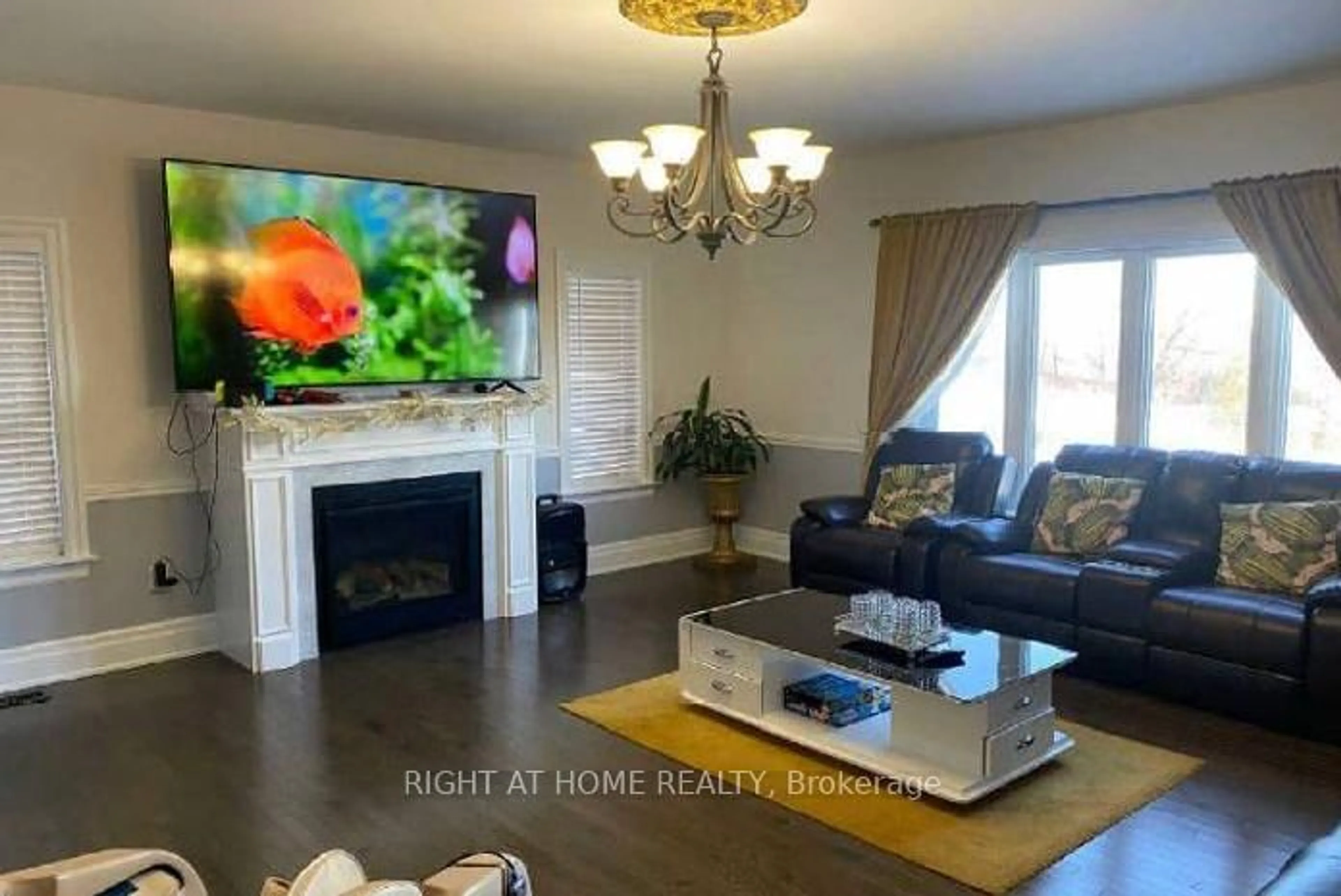 Living room with furniture, wood/laminate floor for 874 John St, Innisfil Ontario L0L 1K0