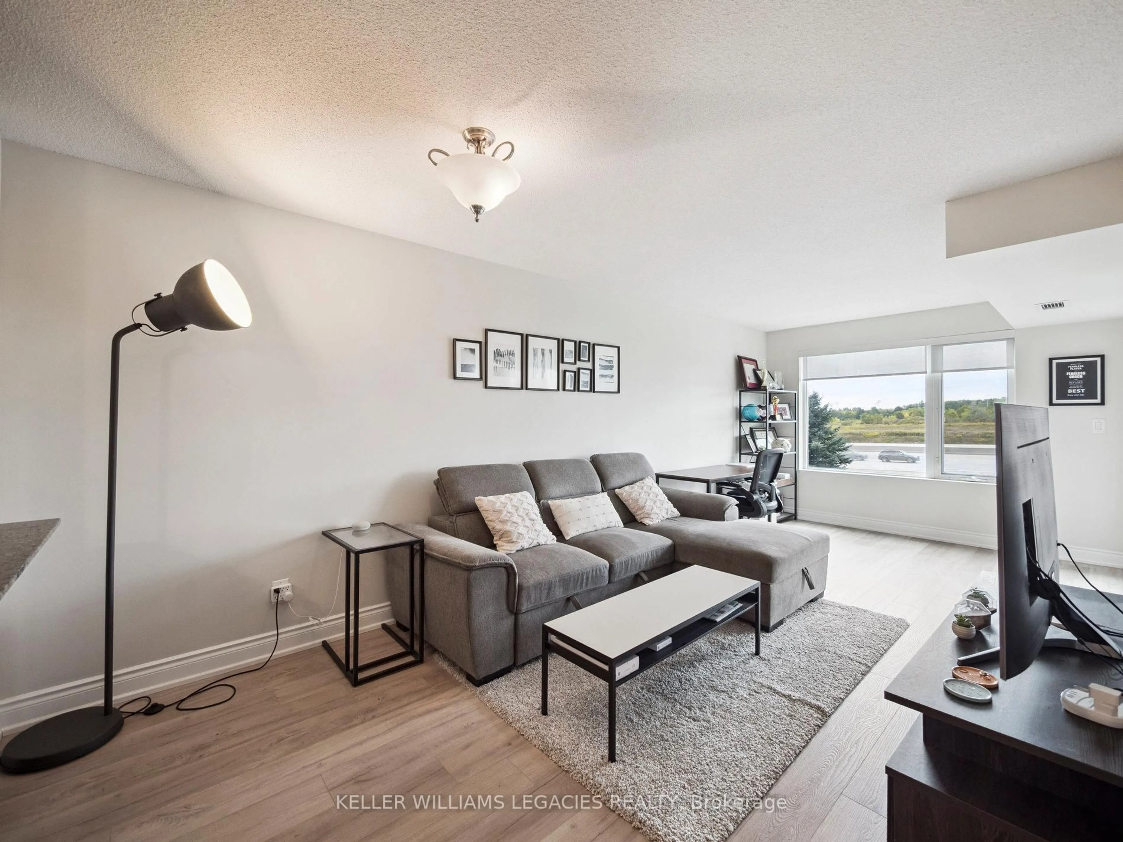 Living room with furniture, wood/laminate floor for 273 South Park Rd #211, Markham Ontario L3T 0B5