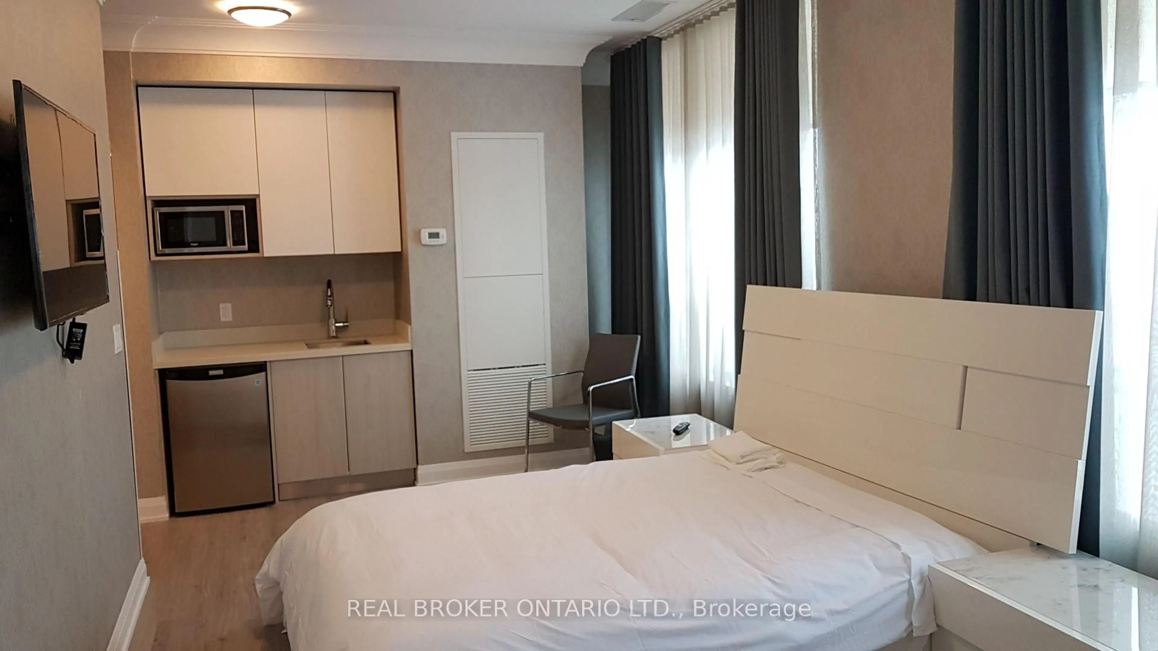 Bedroom with bed, wood/laminate floor for 15 Water Walk Dr #110, Markham Ontario L6G 0G2