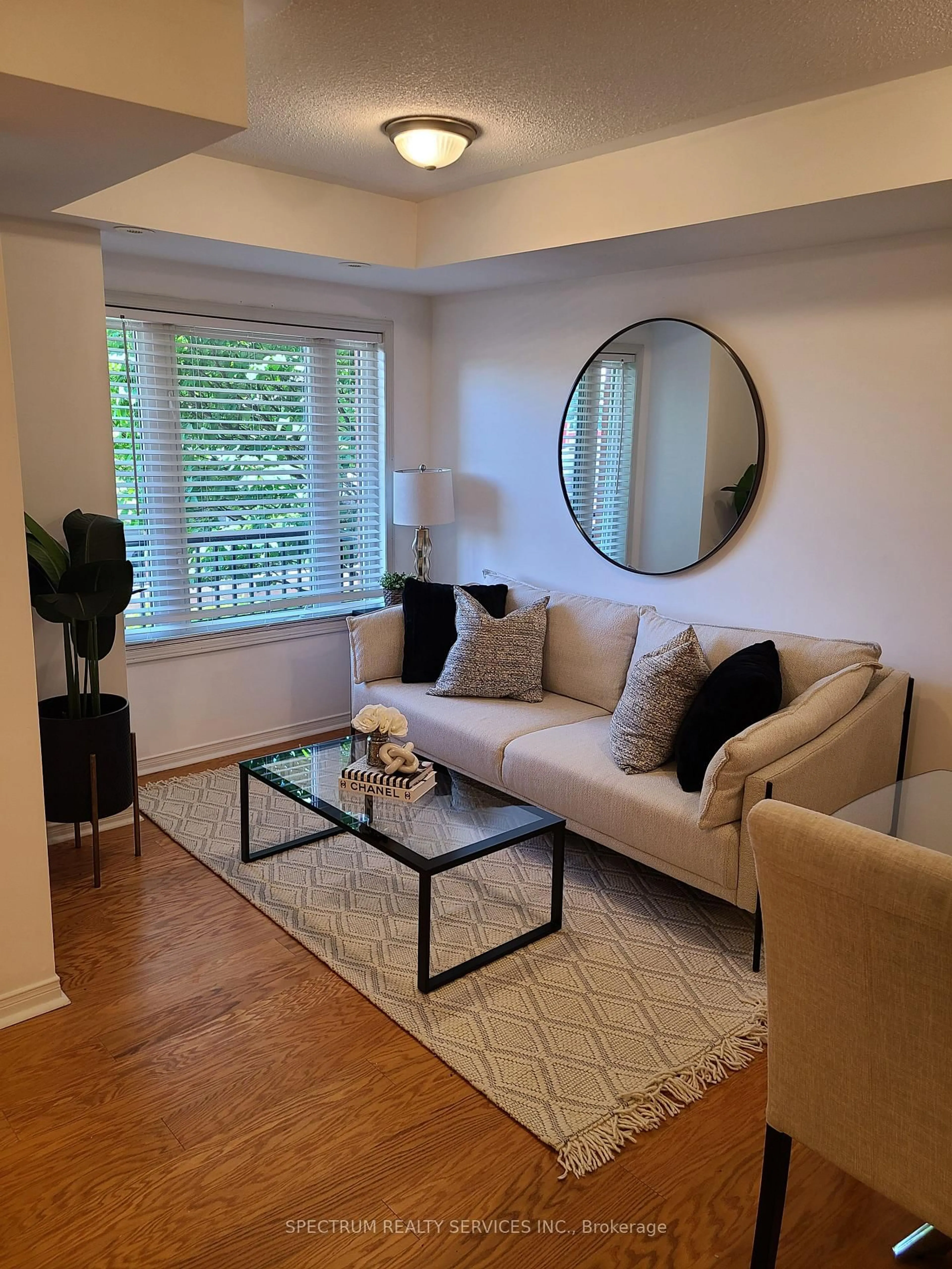 Living room with furniture, wood/laminate floor for 308 John St #203, Markham Ontario L3T 0A7