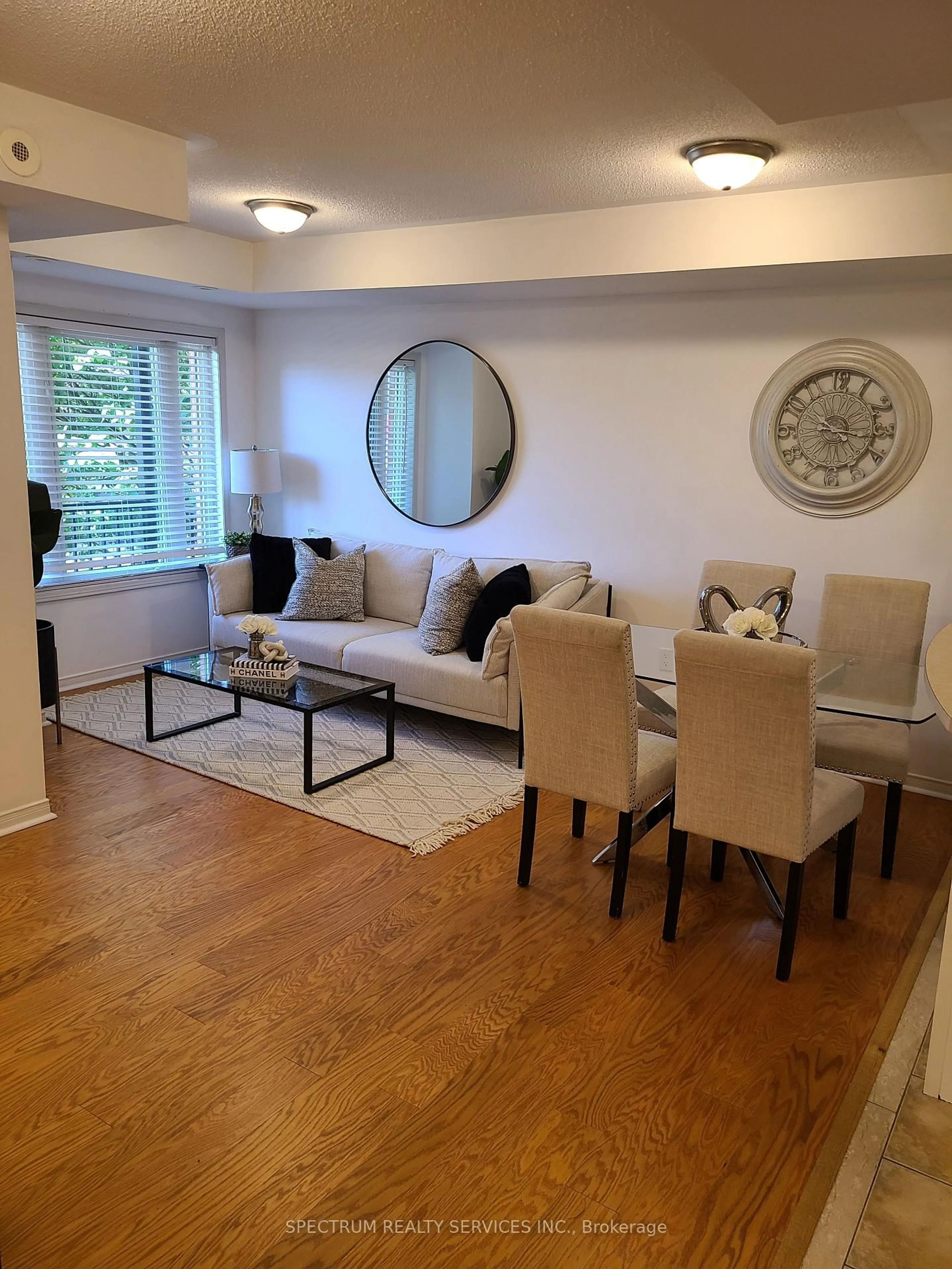 Living room with furniture, wood/laminate floor for 308 John St #203, Markham Ontario L3T 0A7