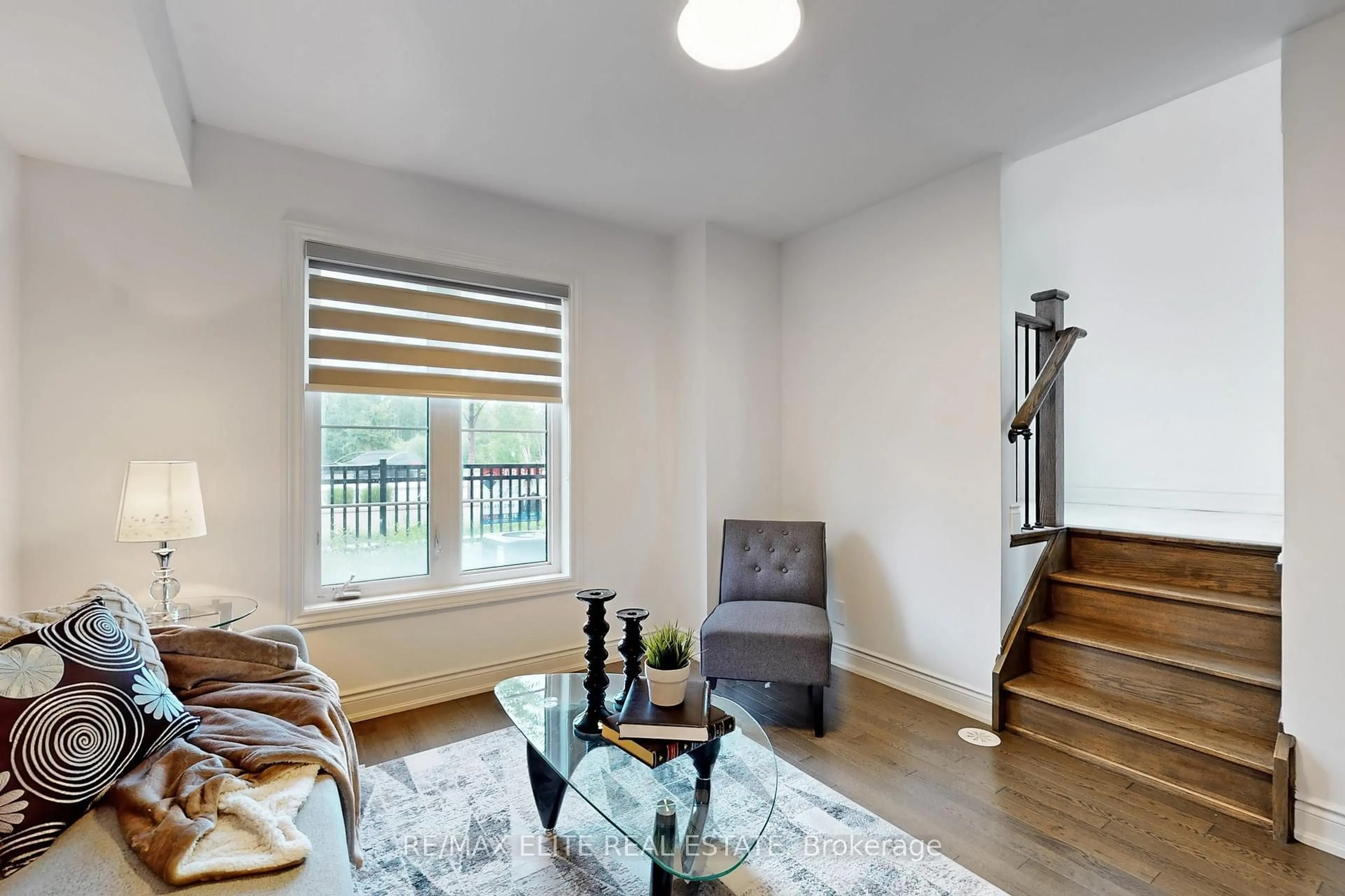 Living room with furniture, wood/laminate floor for 4142 Highway 7 Rd, Markham Ontario L3R 0W9