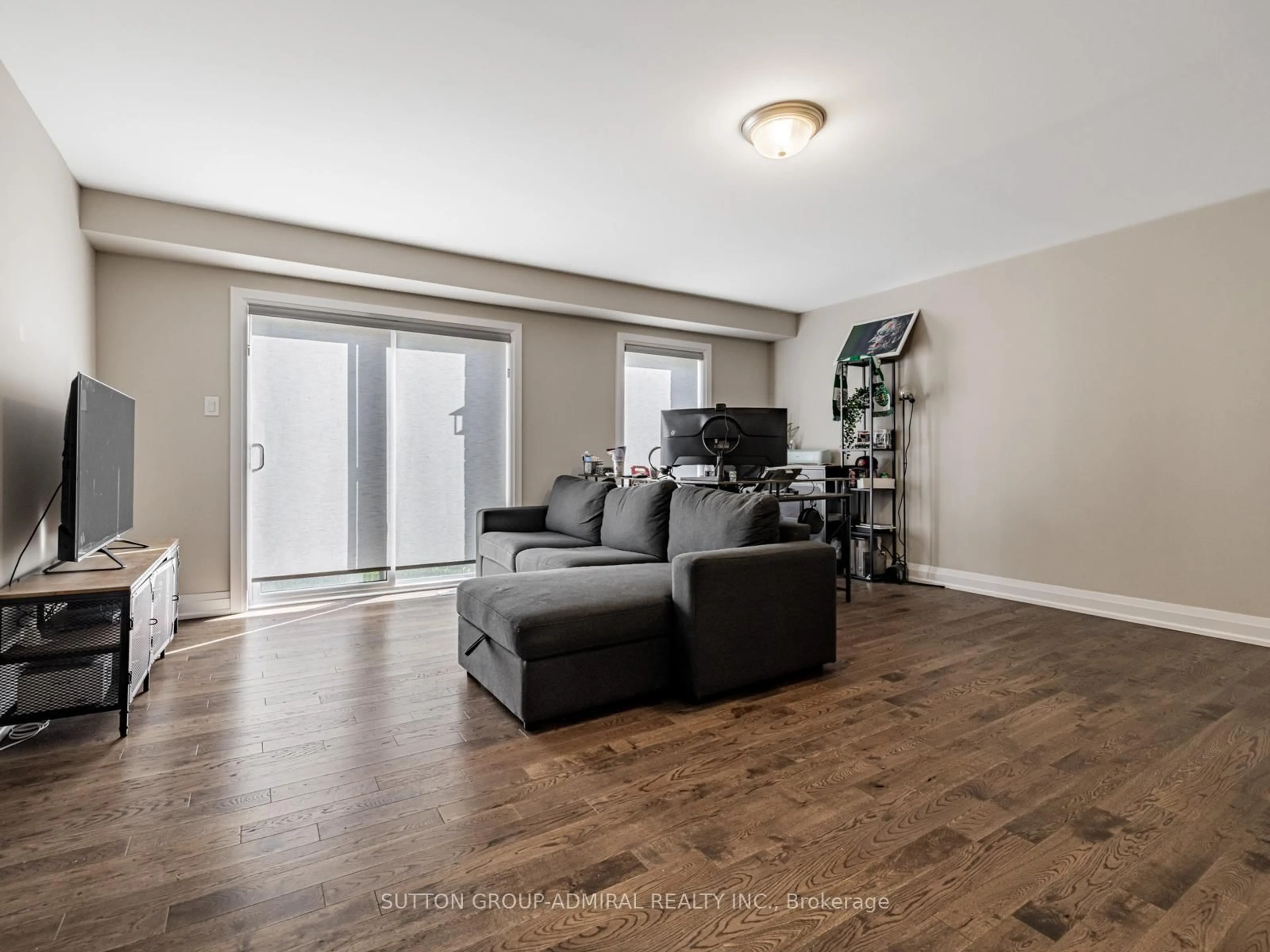 Living room with furniture, wood/laminate floor for 915 Isaac Phillips Way, Newmarket Ontario L3X 2Y8