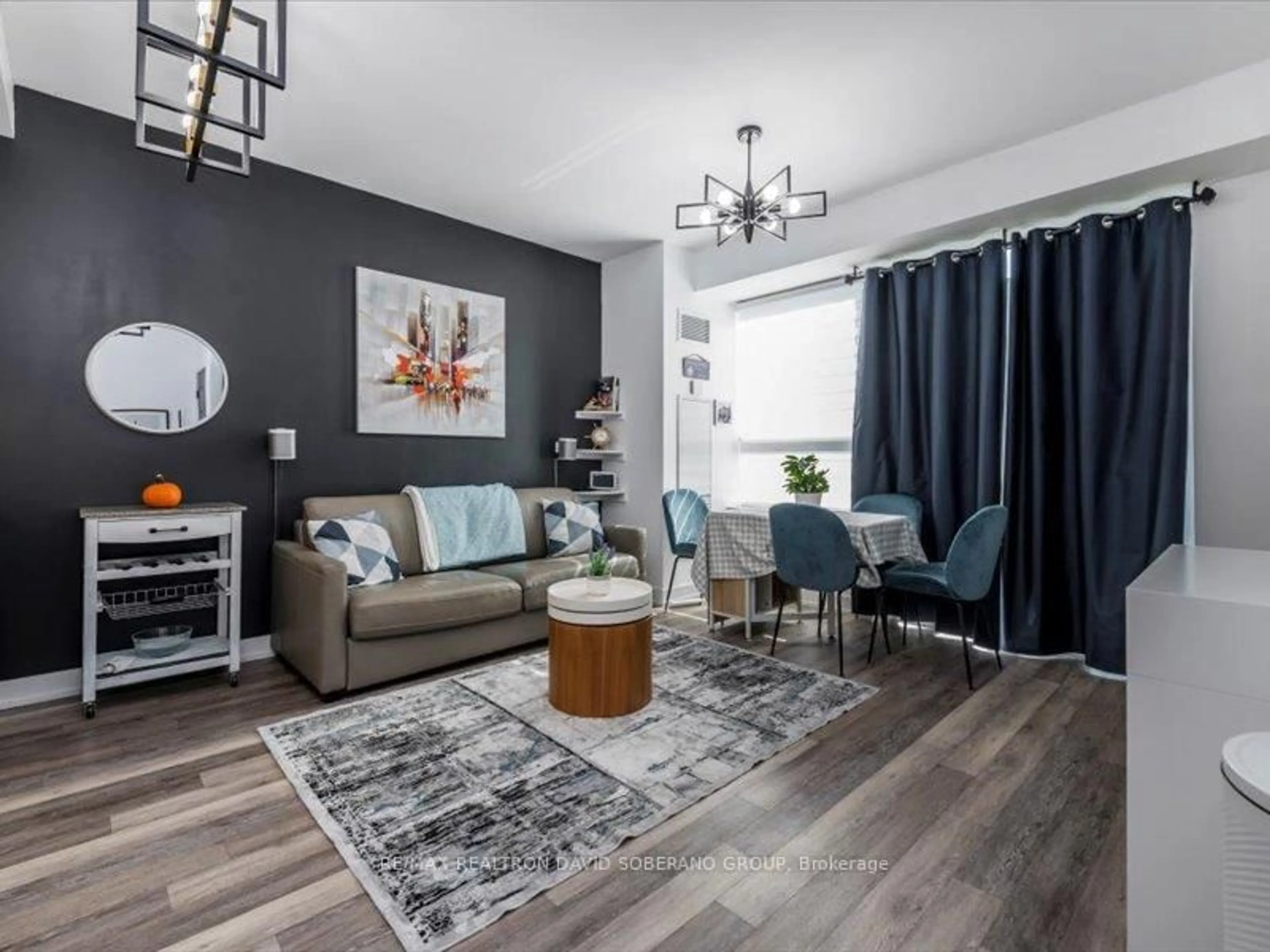 Living room with furniture, wood/laminate floor for 333 Sea Ray Ave #D101, Innisfil Ontario L9S 0L8