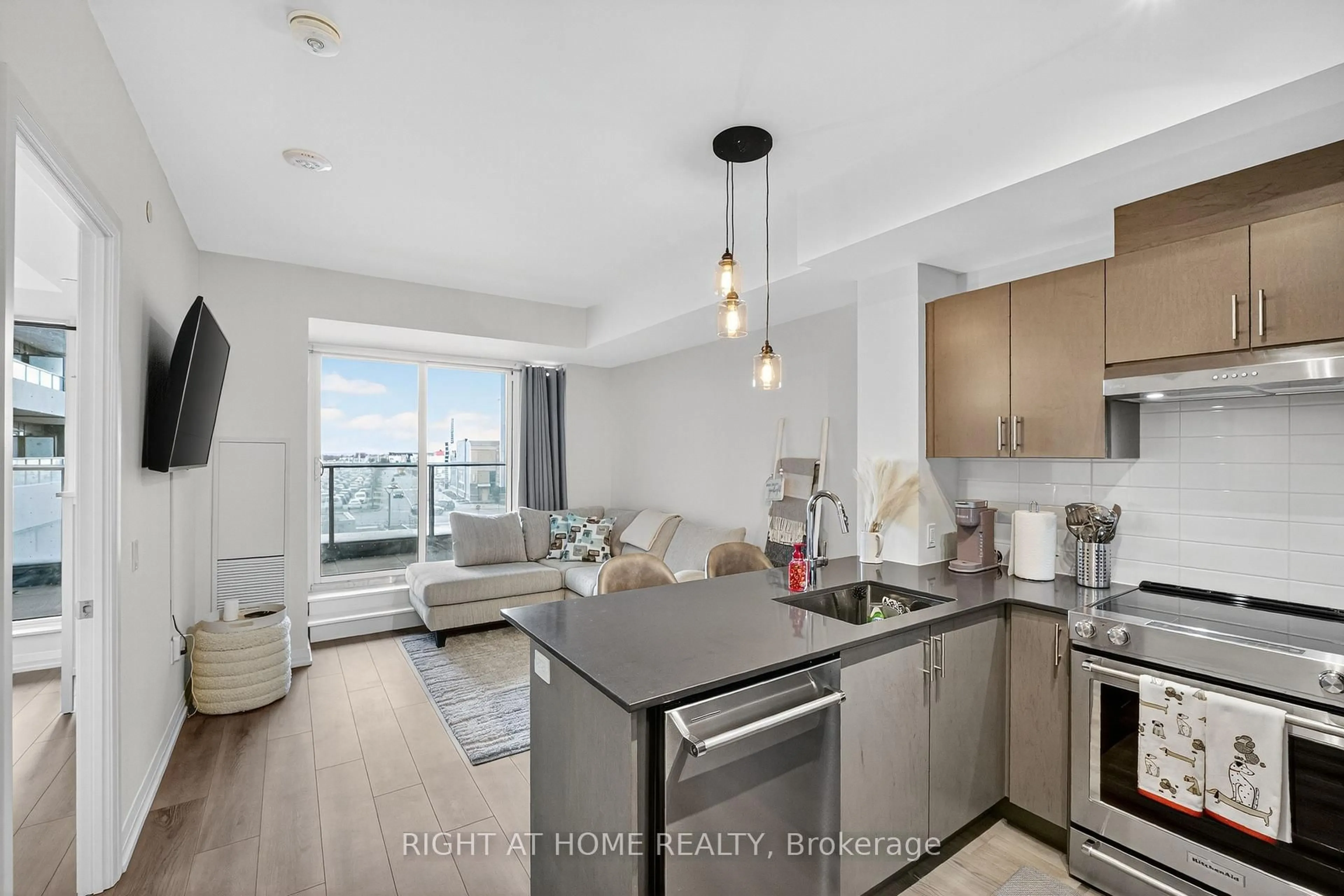 Open concept kitchen, wood/laminate floor for 8960 Jane St #215, Vaughan Ontario L4K 0N9