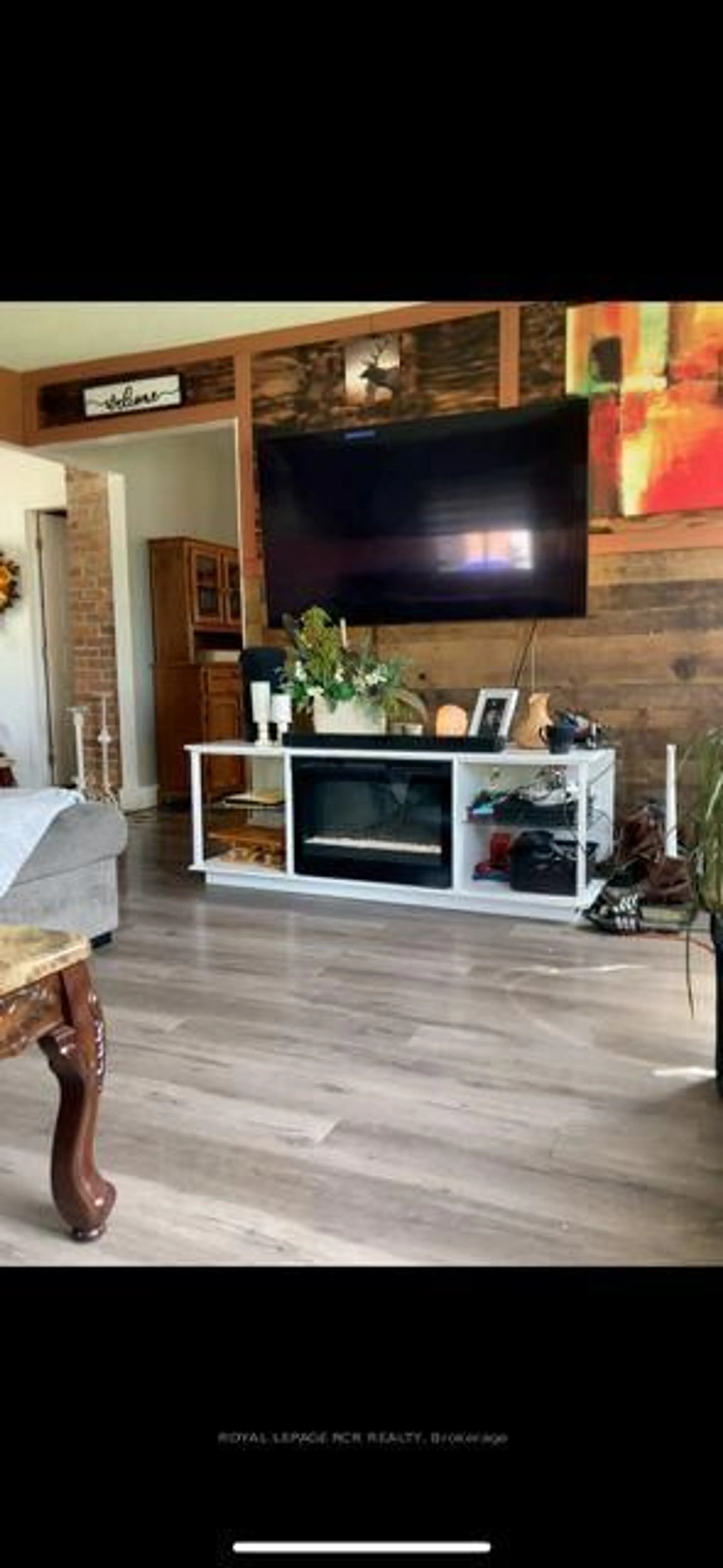 Living room with furniture, wood/laminate floor for 8320 Main St, Adjala-Tosorontio Ontario L0M 1M0