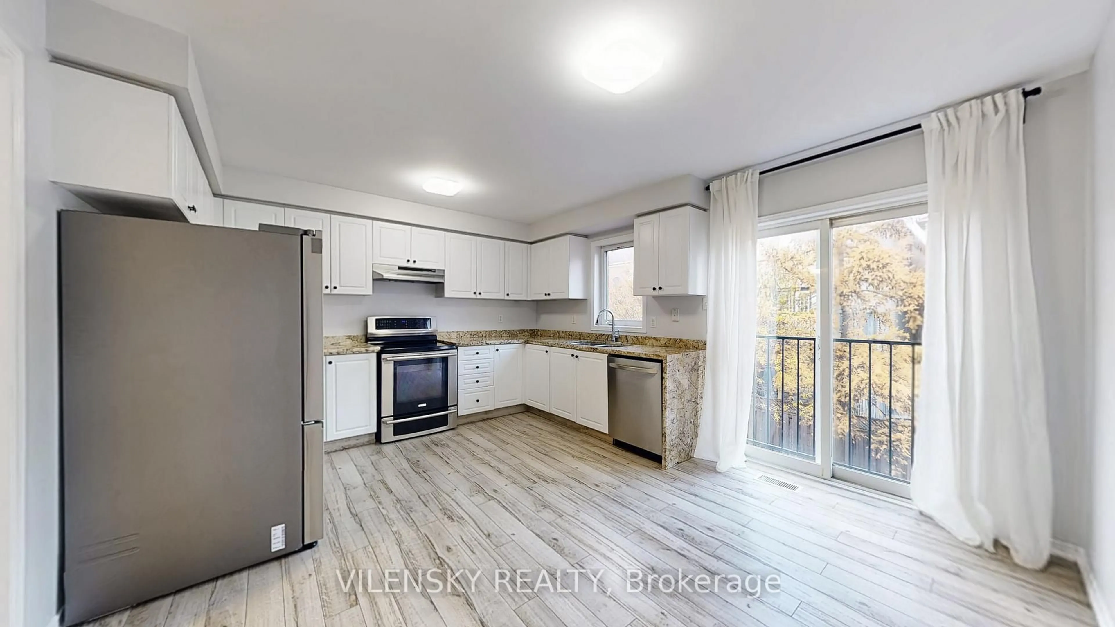 Open concept kitchen, wood/laminate floor for 177 Sassafras Circ, Vaughan Ontario L4J 8M6