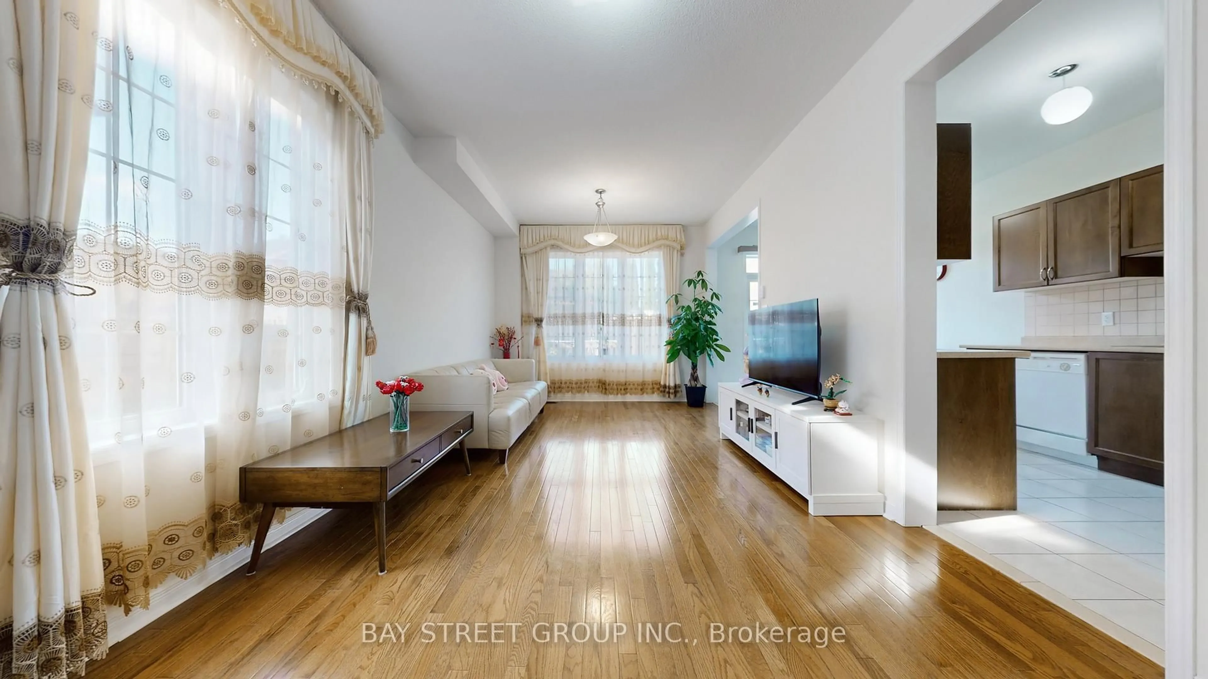 Living room with furniture, wood/laminate floor for 82 Coleluke Lane, Markham Ontario L3S 0B7