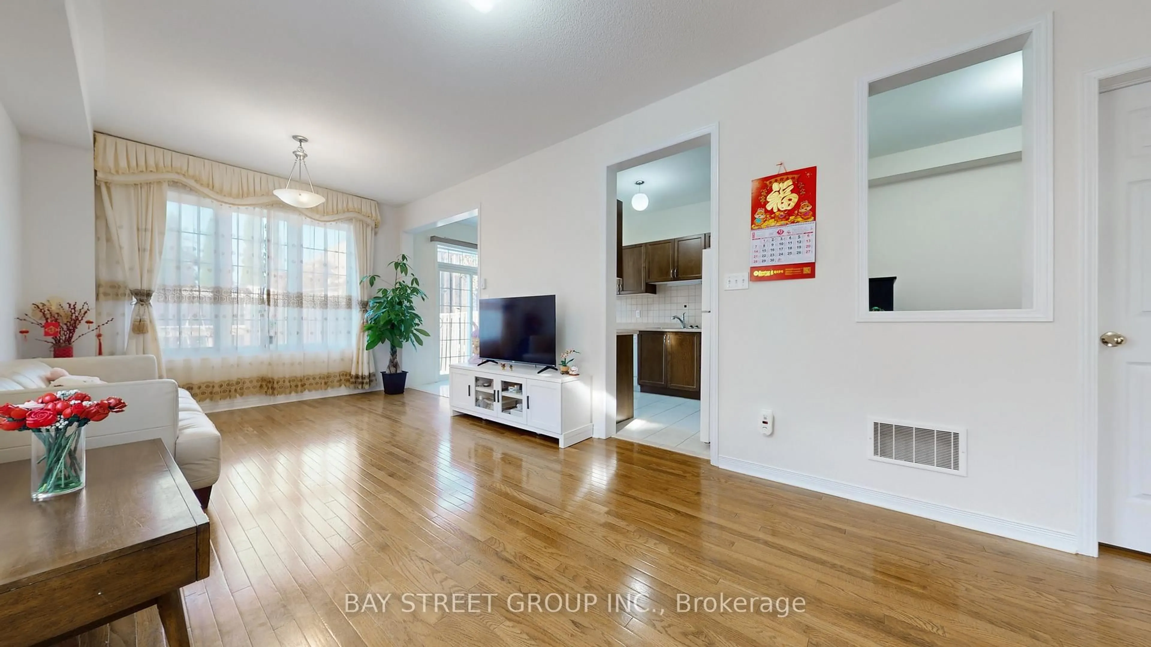 Living room with furniture, wood/laminate floor for 82 Coleluke Lane, Markham Ontario L3S 0B7