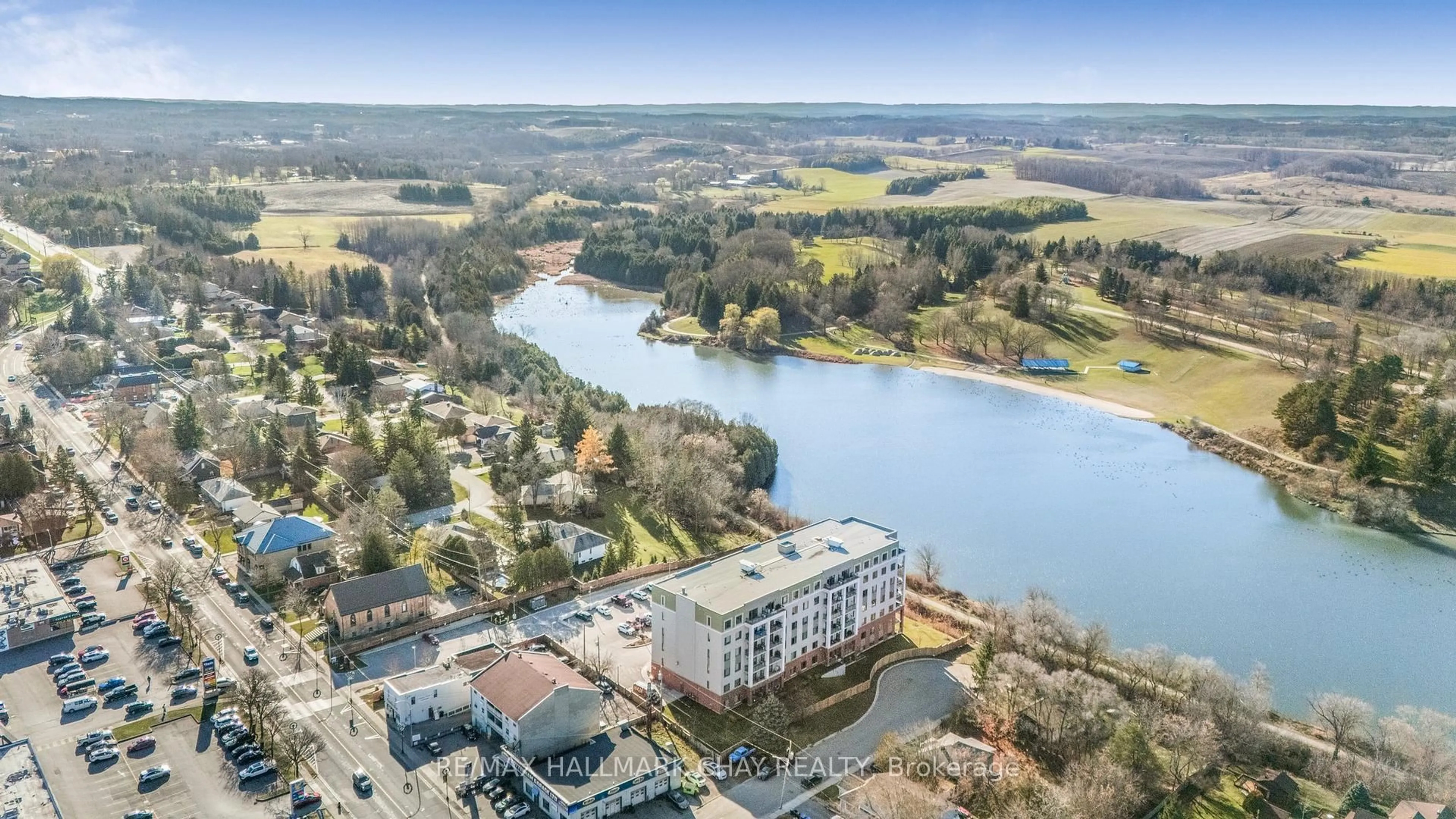 A pic from outside/outdoor area/front of a property/back of a property/a pic from drone, water/lake/river/ocean view for 64 Queen St #107, New Tecumseth Ontario L0G 1W0