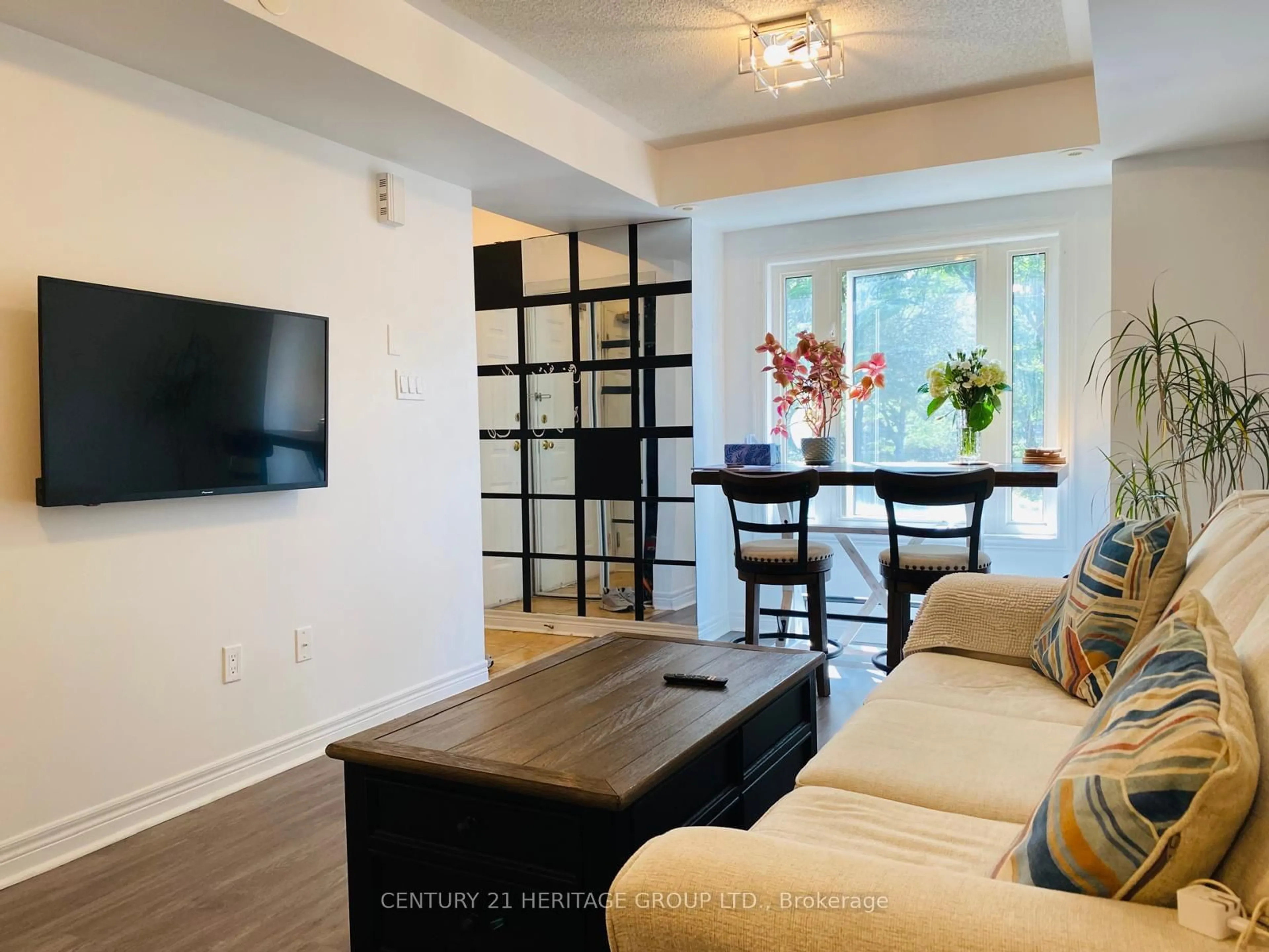Living room with furniture, wood/laminate floor for 316 John St #262, Markham Ontario L3T 0A7