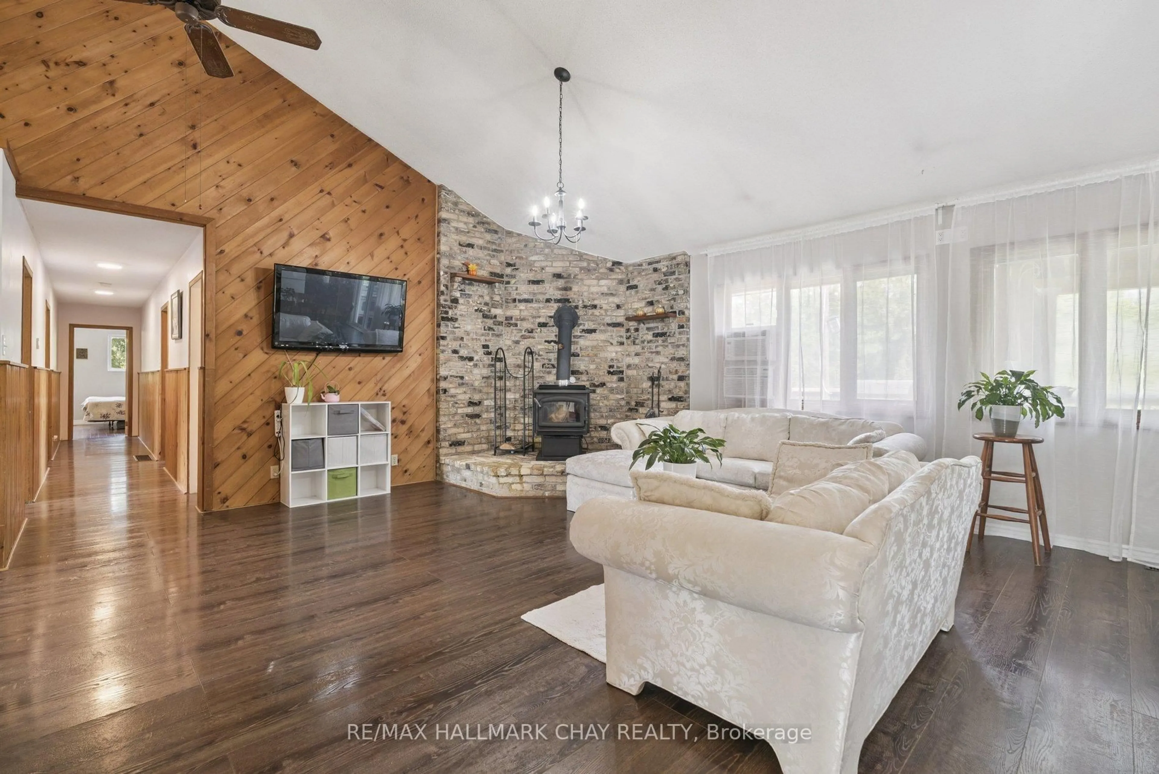 Living room with furniture, wood/laminate floor for 7521 County Road 10, Essa Ontario L0M 1B1