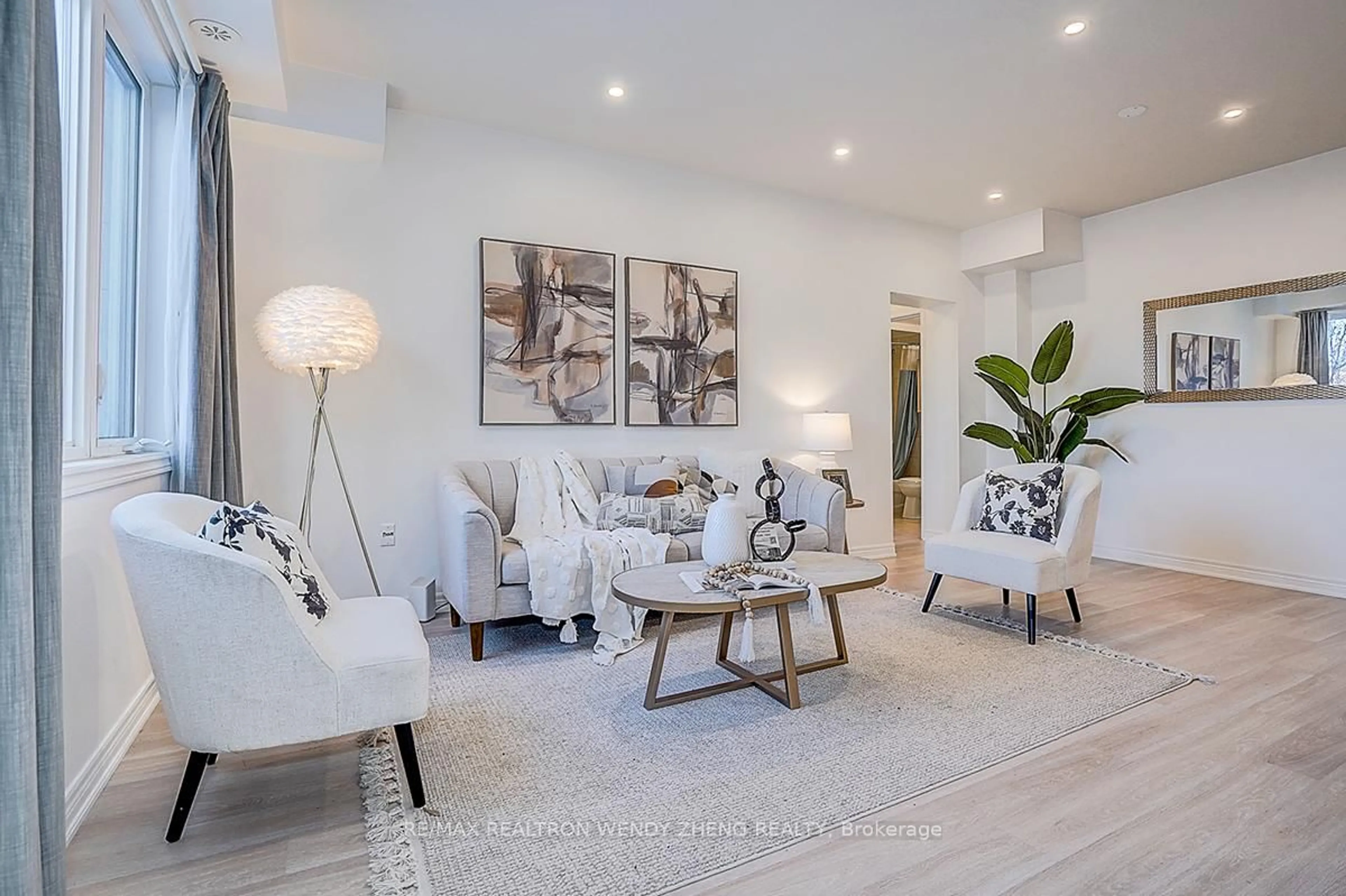 Living room with furniture, wood/laminate floor for 261 Aldergrove Dr, Markham Ontario L3R 2L8