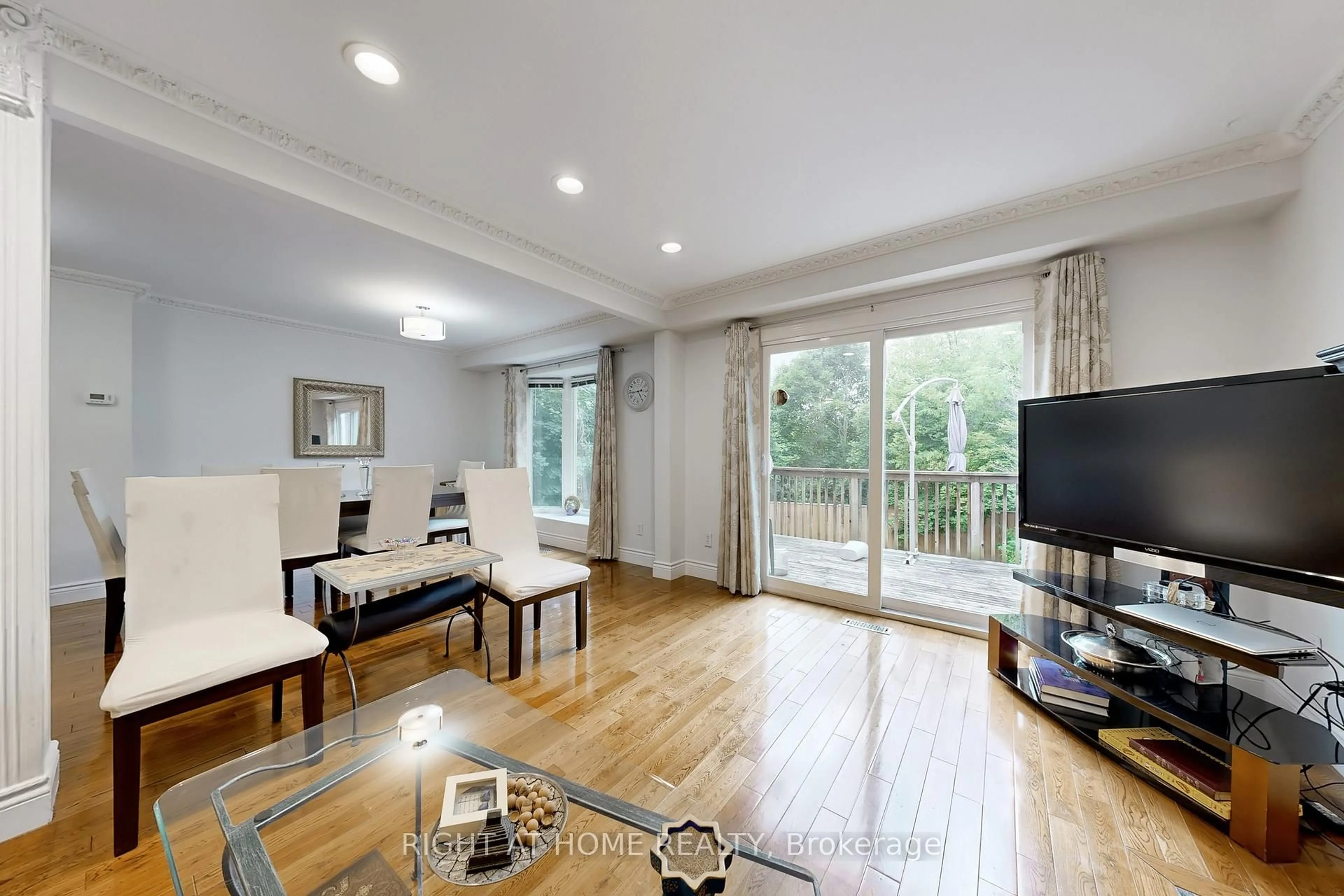 Living room with furniture, wood/laminate floor for 52 Breckonwood Cres, Markham Ontario L3T 5E8