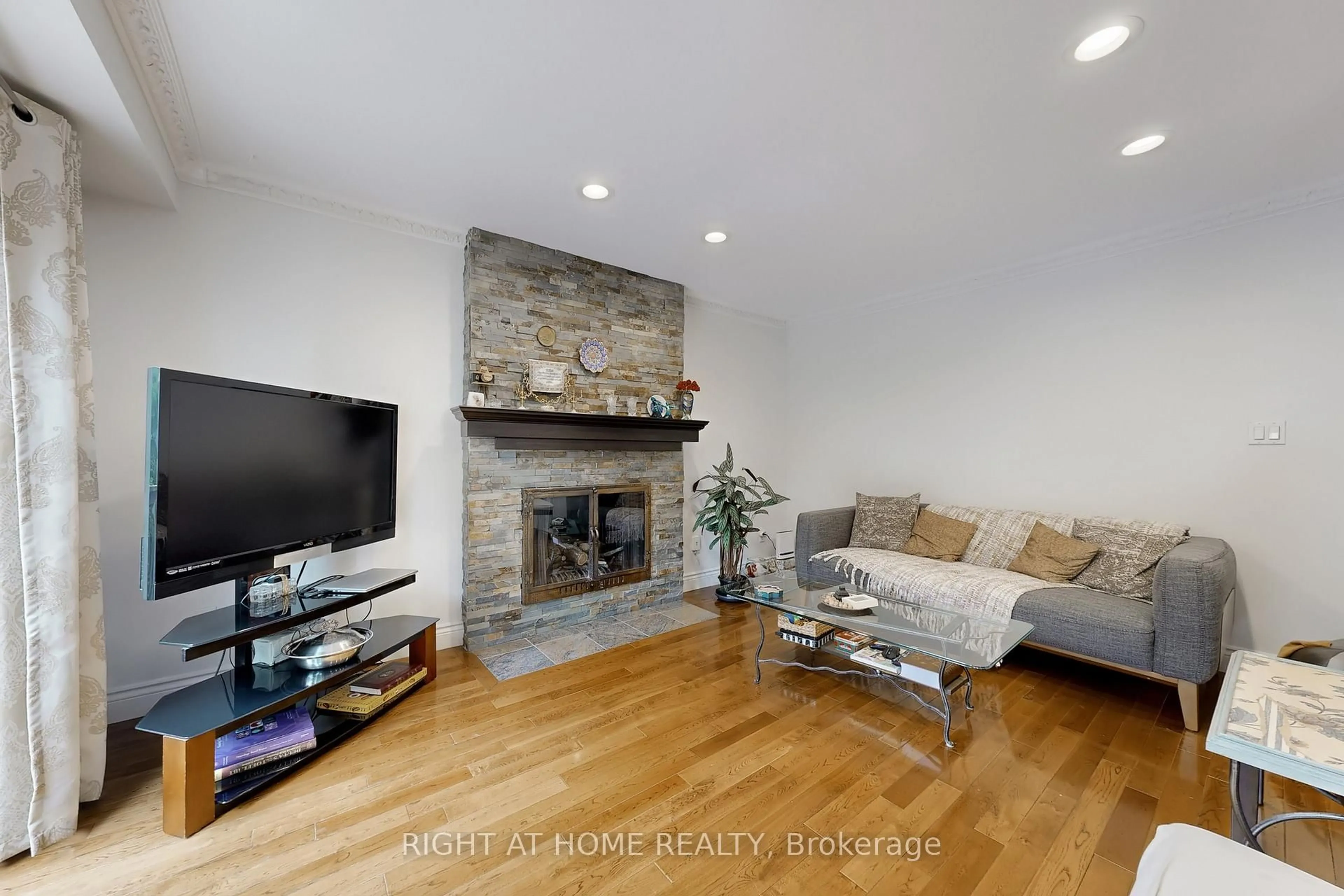 Living room with furniture, wood/laminate floor for 52 Breckonwood Cres, Markham Ontario L3T 5E8