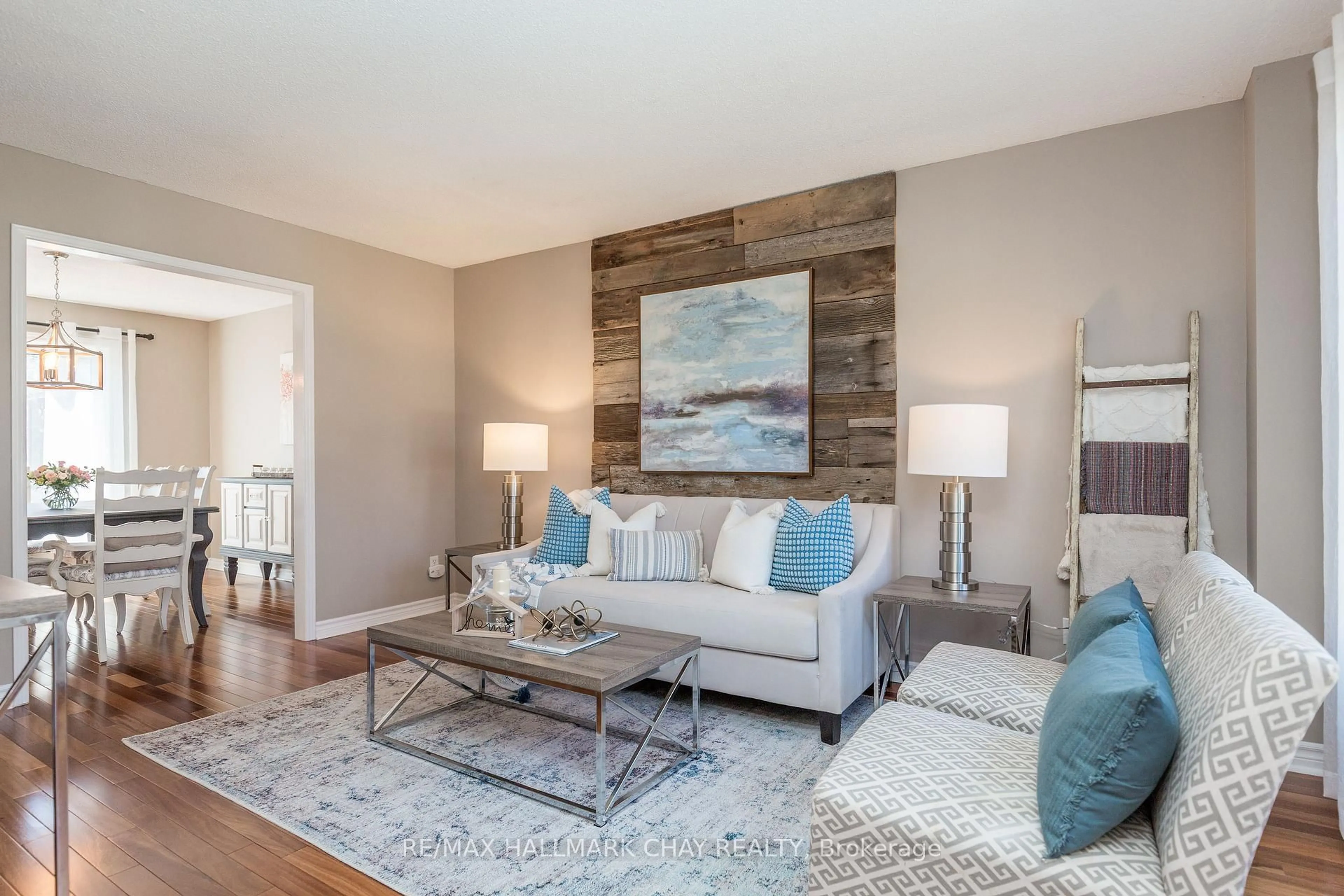 Living room with furniture, wood/laminate floor for 11 Heritage Rd, Innisfil Ontario L0L 1L0