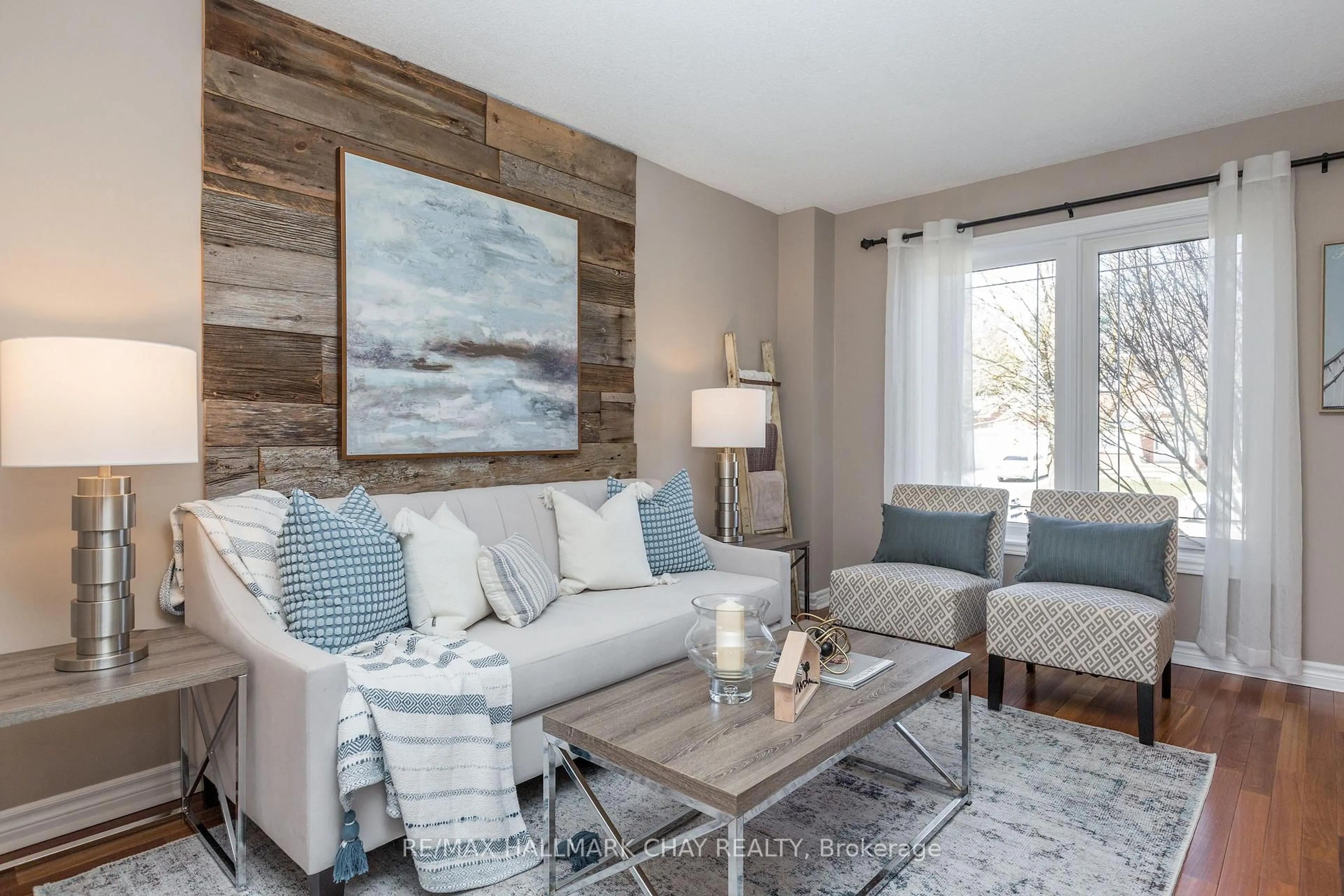 Living room with furniture, wood/laminate floor for 11 Heritage Rd, Innisfil Ontario L0L 1L0